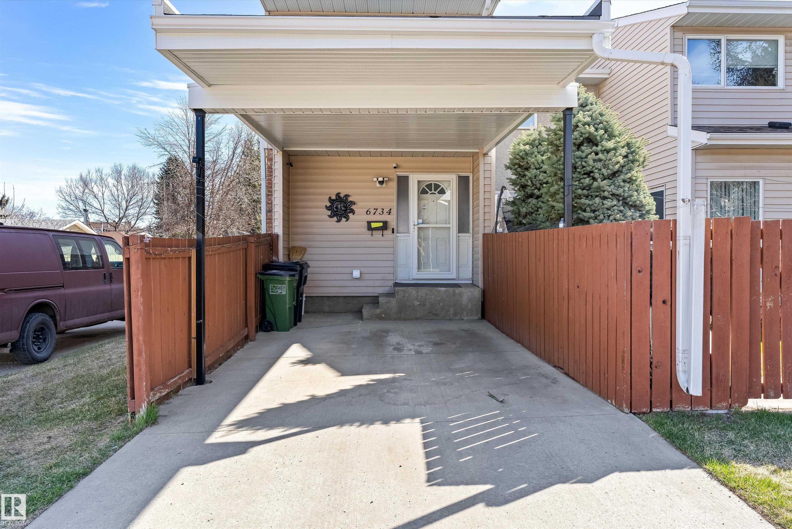 Two-story residence featuring light-colored siding and a covered carport - 6734 36A Avenue, Edmonton, AB - Outdoor With Exterior