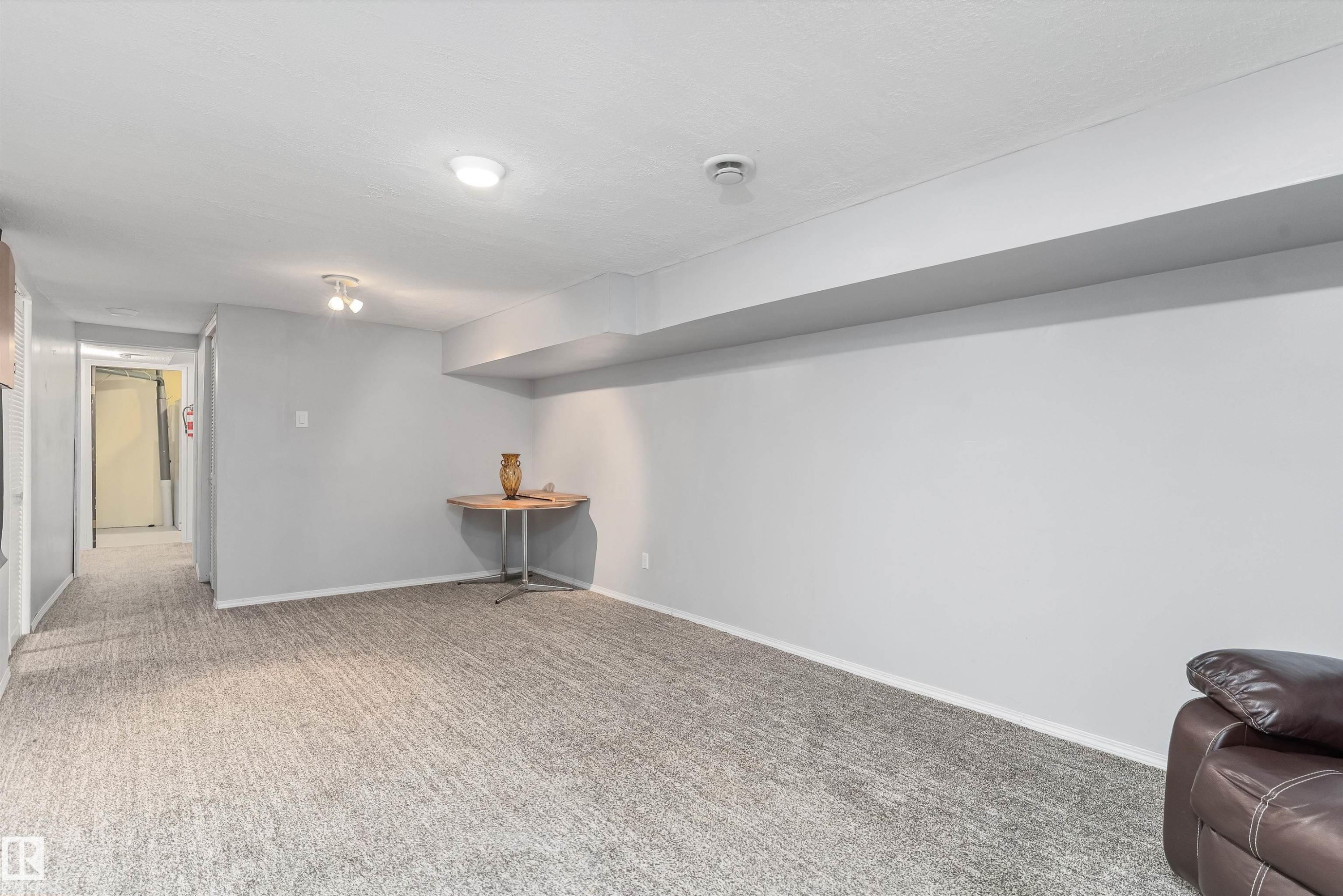 Spacious room featuring light gray walls, textured gray carpeting, and recessed lighting - 6734 36A Avenue, Edmonton, AB - Indoor Photo Showing Other Room