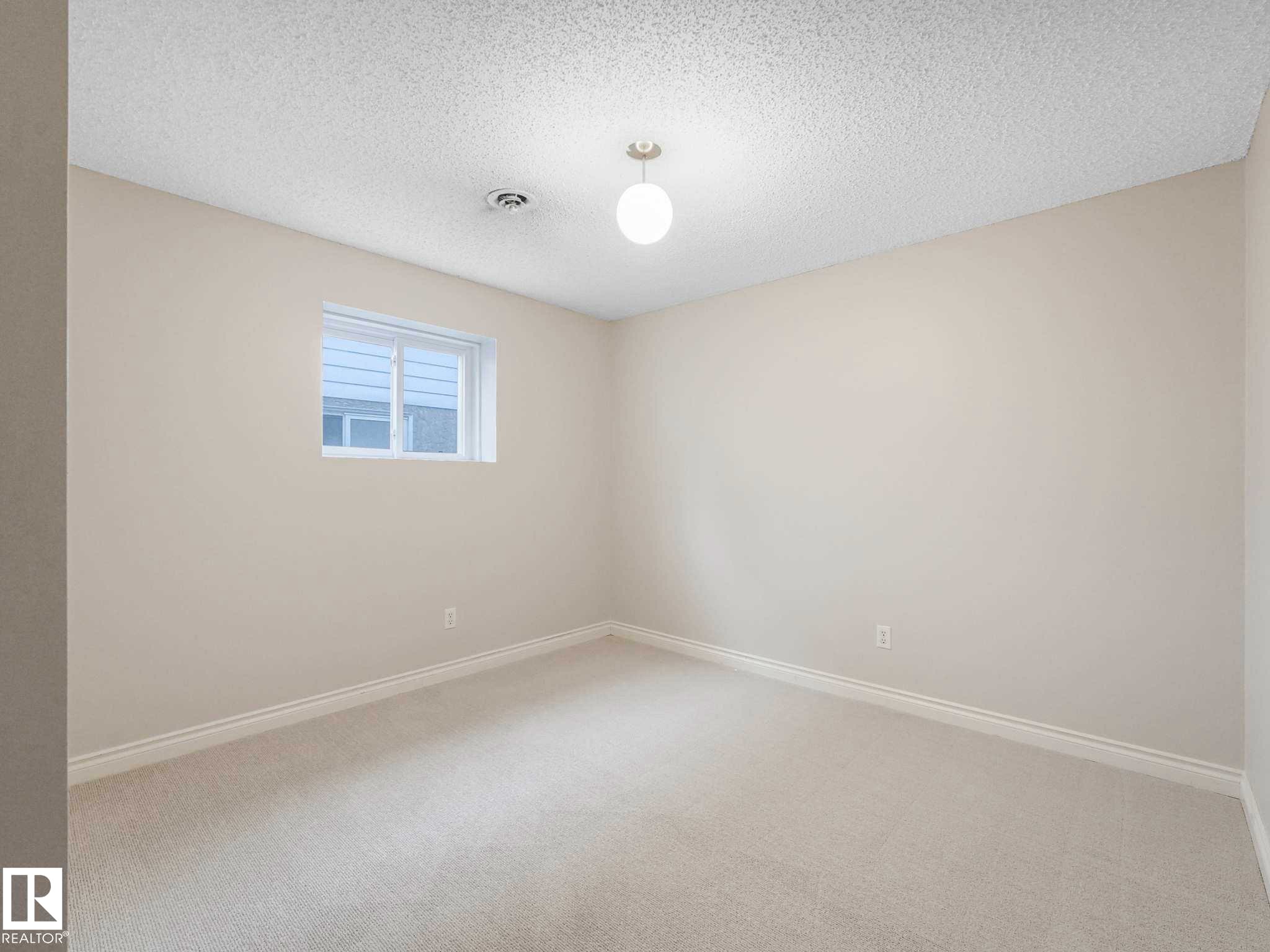Bright room featuring light-toned carpeting, neutral wall paint, and white trim - 4011 104 Street, Edmonton, AB - Indoor Photo Showing Other Room