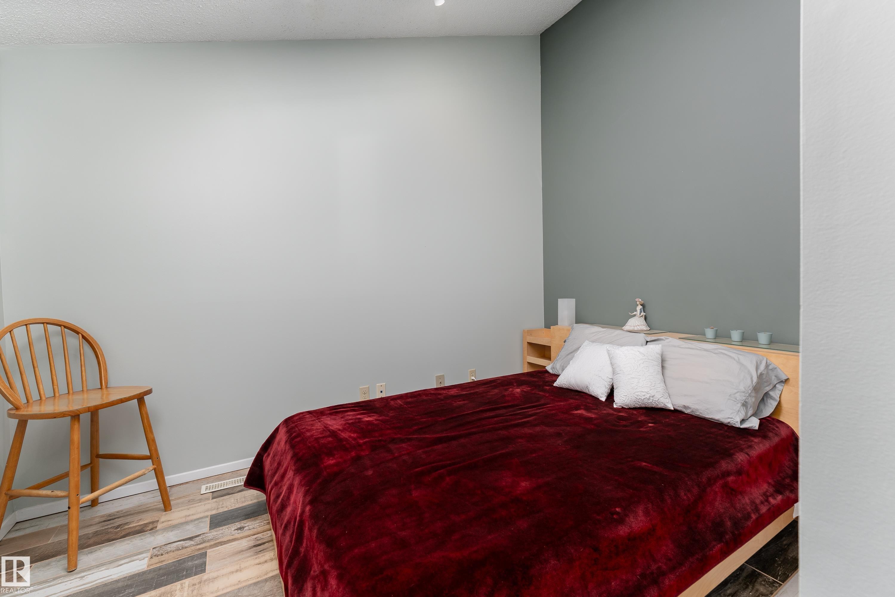 Main floor bedroom near back-entry, ideal for home office or guest suite. Vaulted ceiling with skylight - 10956 81 Avenue, Edmonton, AB - Indoor Photo Showing Bedroom