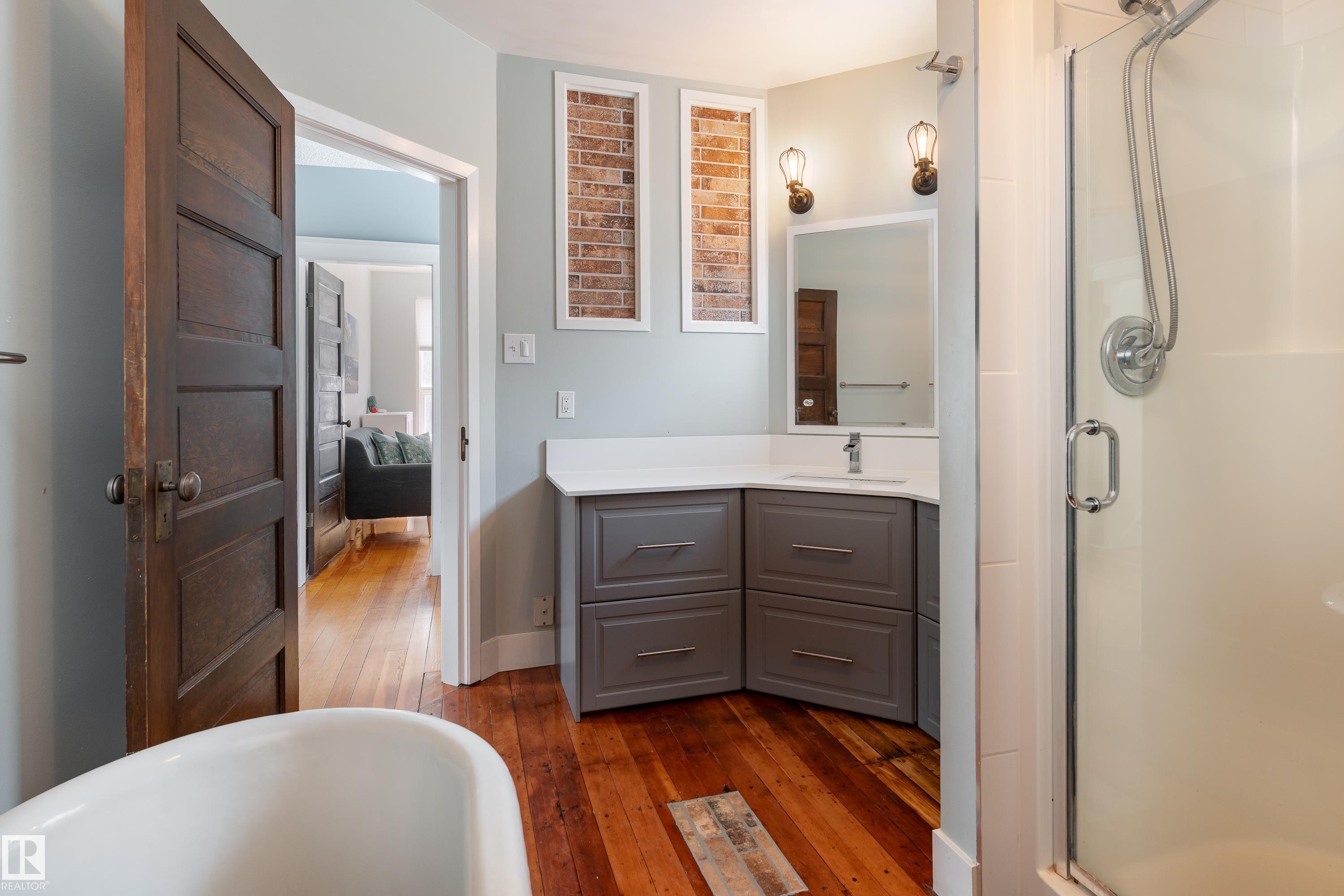 Updated bath with claw-foot tub and stand-up shower, 2nd floor - 10956 81 Avenue, Edmonton, AB - Indoor Photo Showing Bathroom