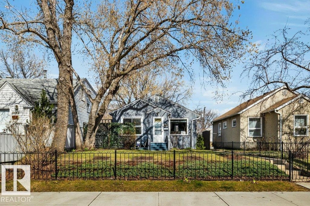 Single-story residence featuring a blue exterior and a prominent front yard - 11445 68 Street, Edmonton, AB - Outdoor