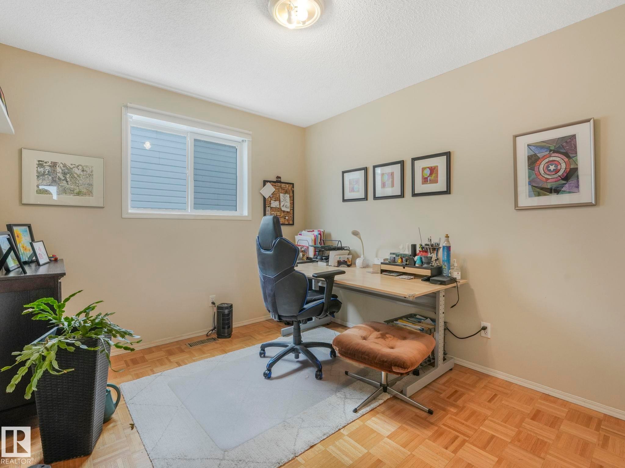 This room features wood parquet flooring, a white window frame, and neutral-toned walls - 308 Beringer Crescent, Edmonton, AB - Indoor Photo Showing Office