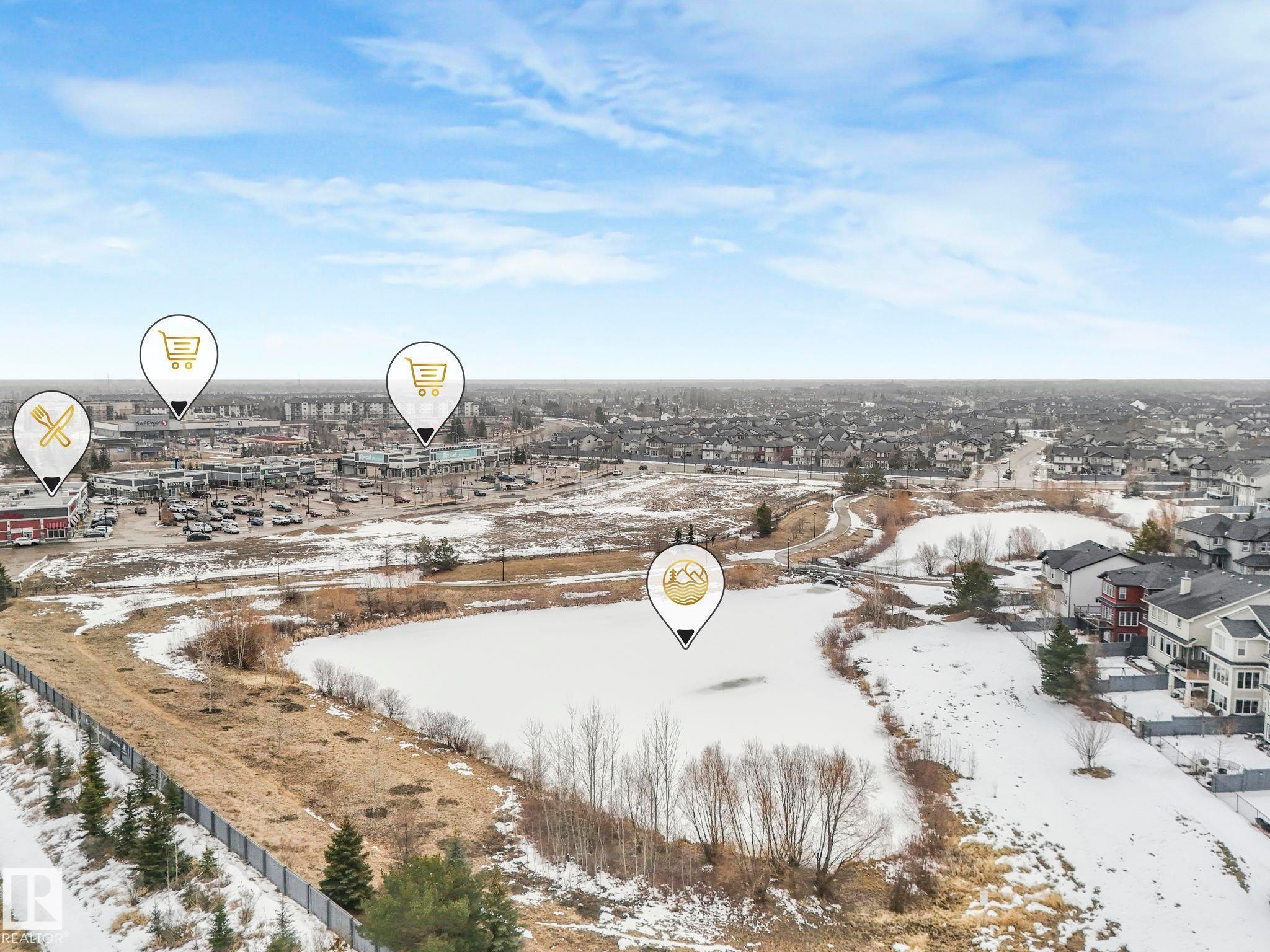 Enjoy a view of the surrounding community, featuring a lake, residential properties, and nearby commercial amenities - 308 Beringer Crescent, Edmonton, AB - Outdoor With View