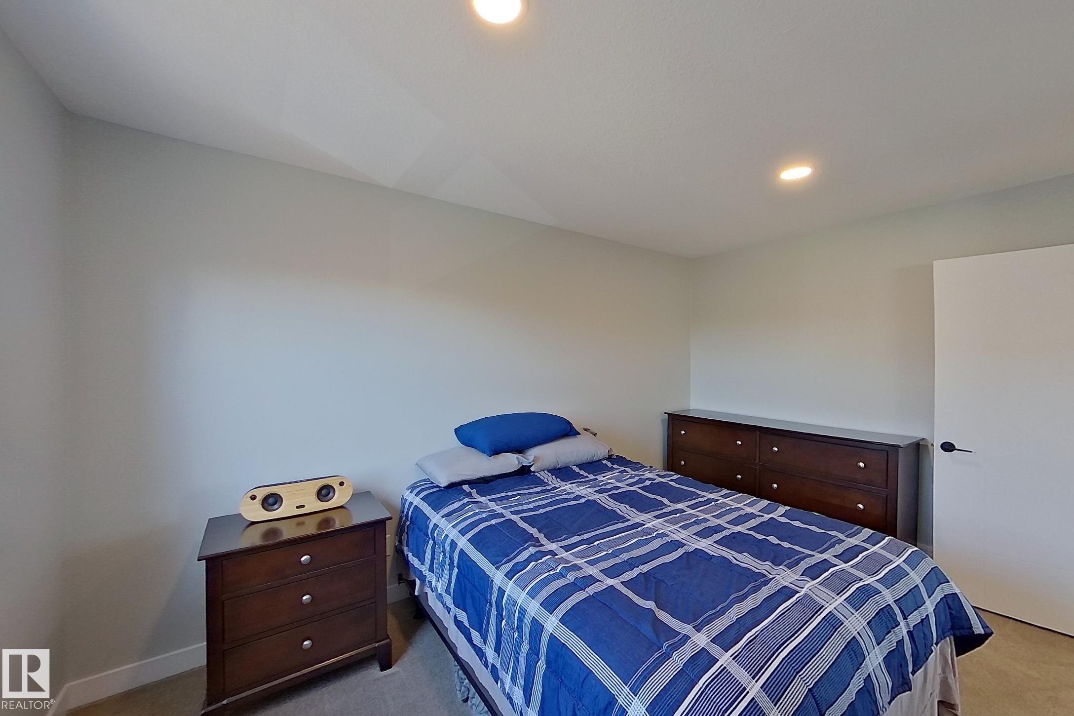 Recessed lighting illuminates neutral-toned walls and plush carpet flooring - 33 150 Everitt Dr, St. Albert, AB - Indoor Photo Showing Bedroom