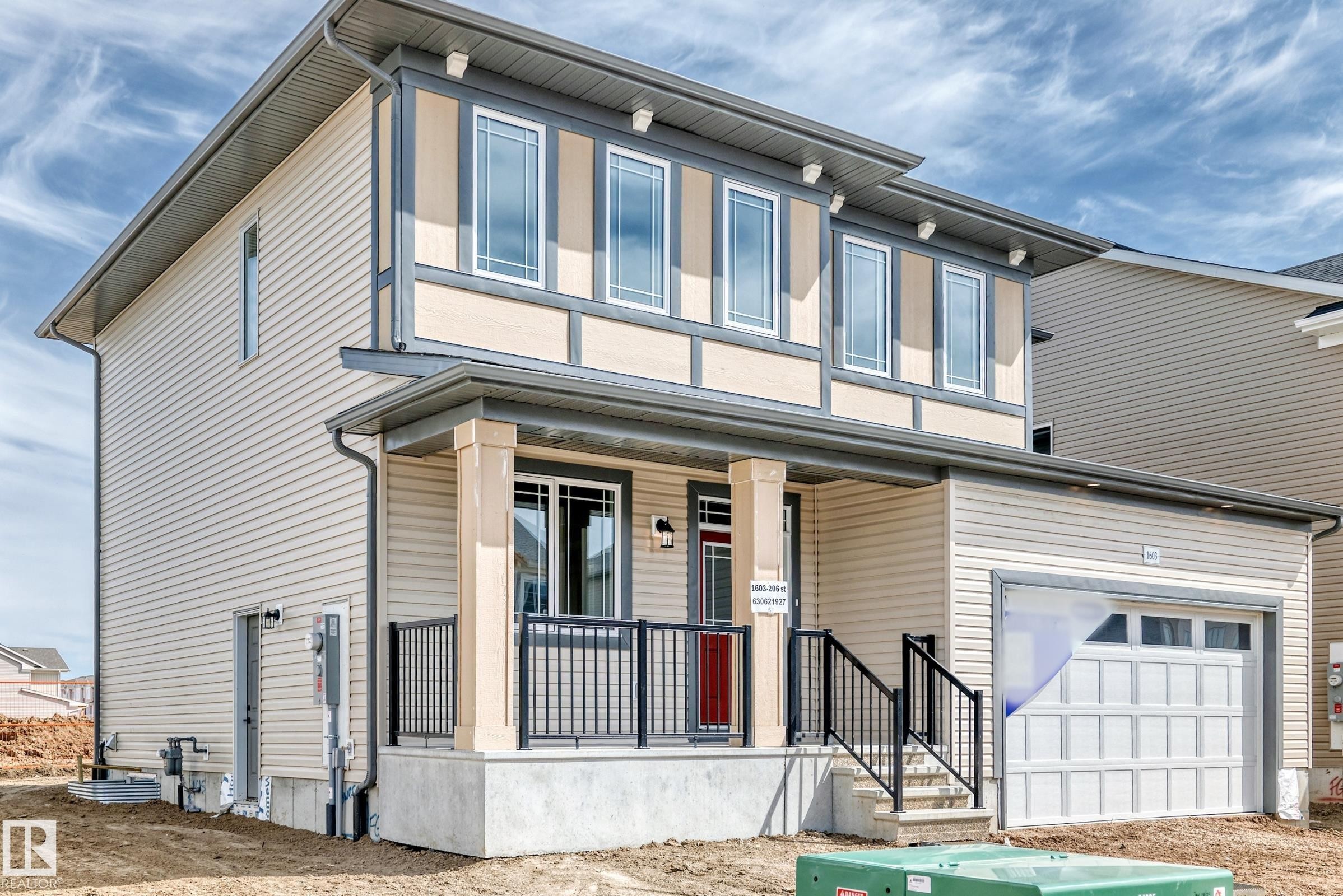 Two-story residence featuring light beige siding and dark trim accents - 1603 206 Street, Edmonton, AB - Outdoor