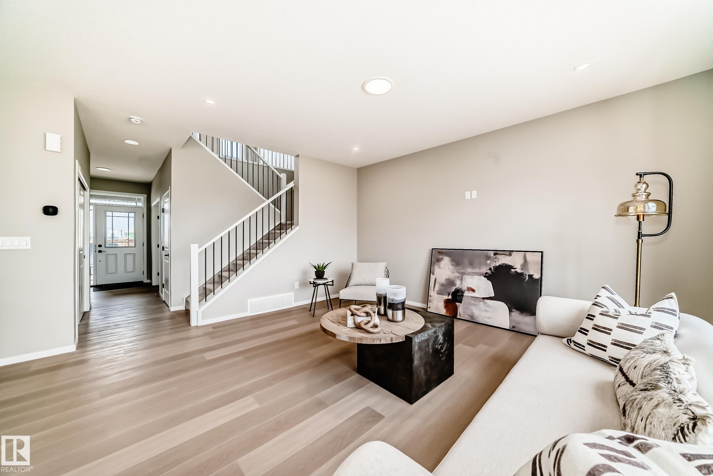 Open concept living area featuring light wood-finish flooring - 1603 206 Street, Edmonton, AB - Indoor