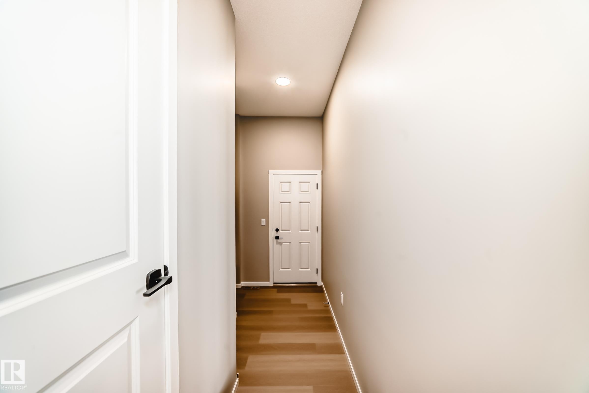 Hallway with wood-finish flooring, light neutral walls, and a recessed ceiling light - 1603 206 Street, Edmonton, AB - Indoor Photo Showing Other Room