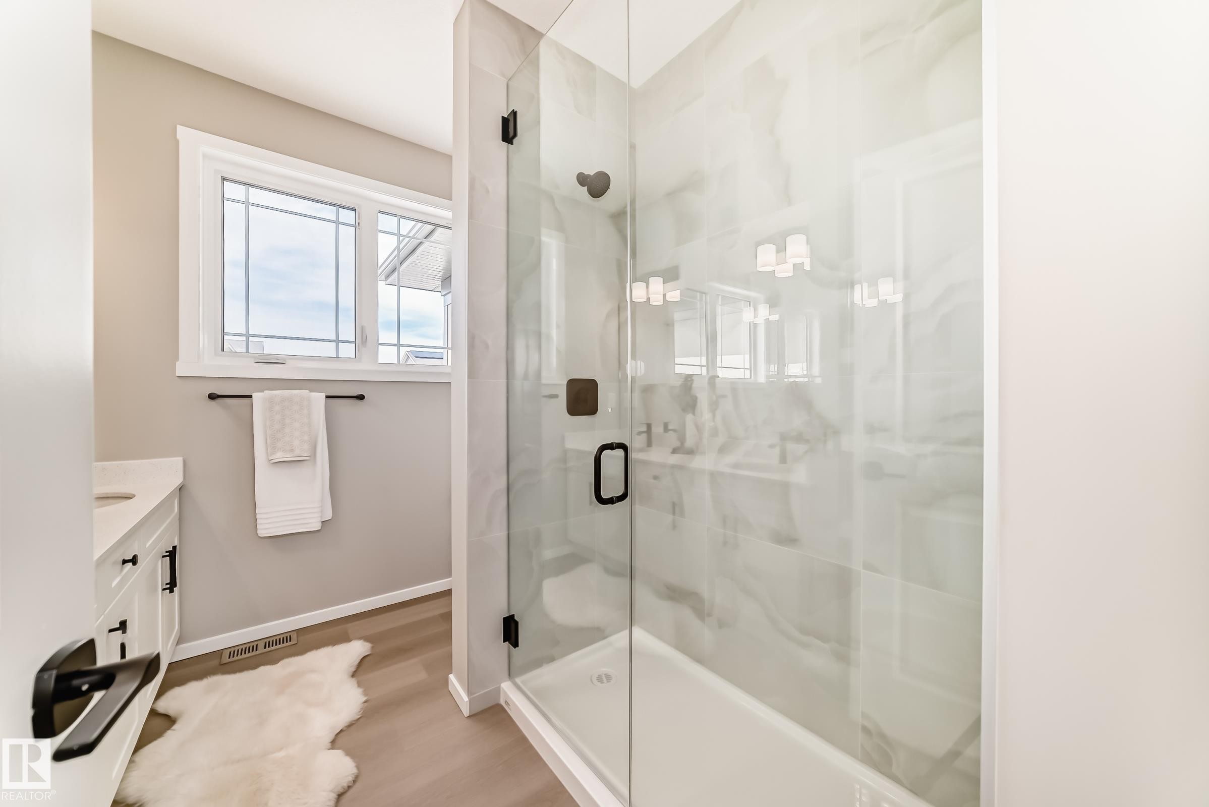 Glass-enclosed shower with contrasting dark fixtures, set against a tiled wall - 1603 206 Street, Edmonton, AB - Indoor Photo Showing Bathroom