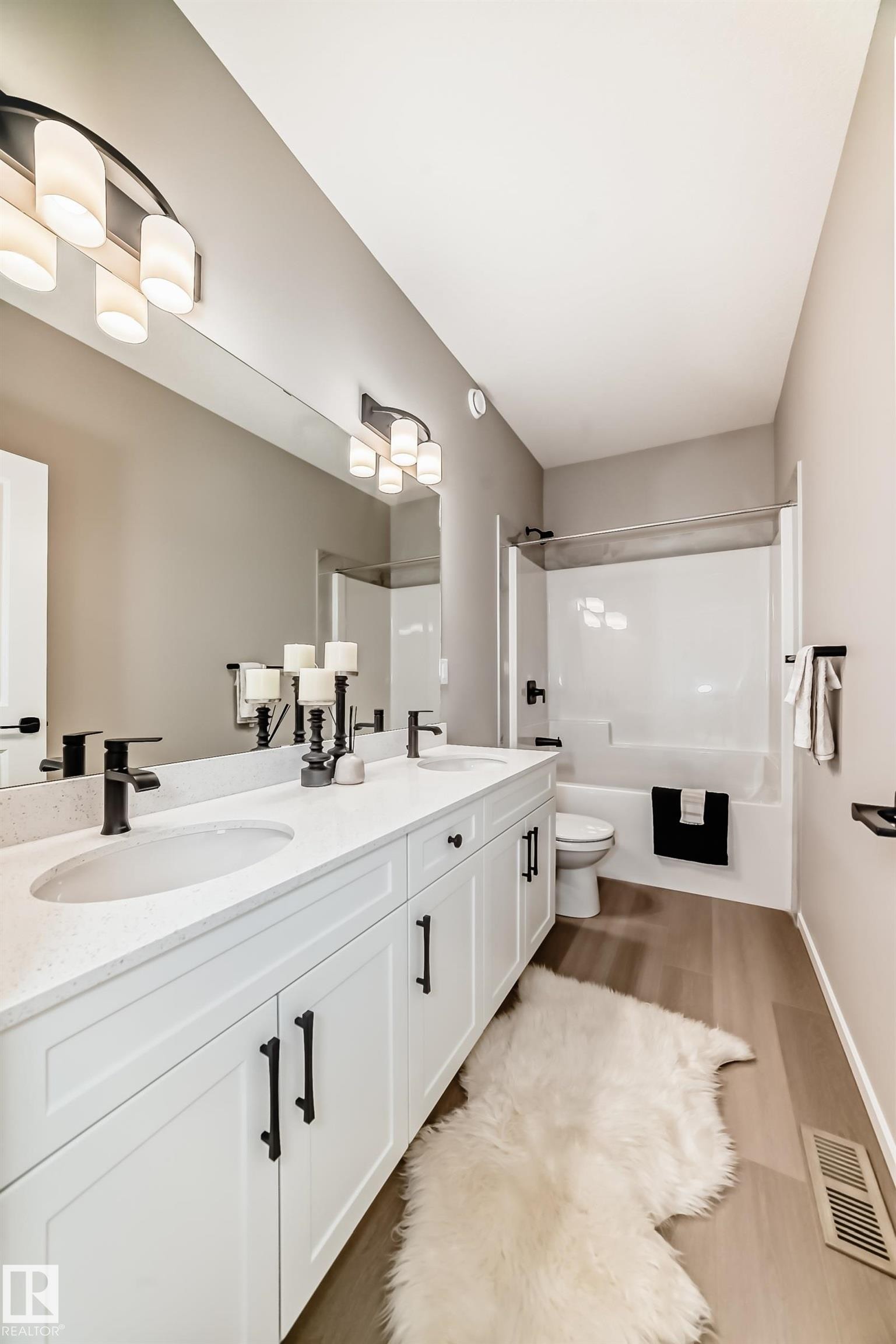 Double vanity with white cabinetry, matte black hardware, and quartz countertops - 1603 206 Street, Edmonton, AB - Indoor Photo Showing Bathroom