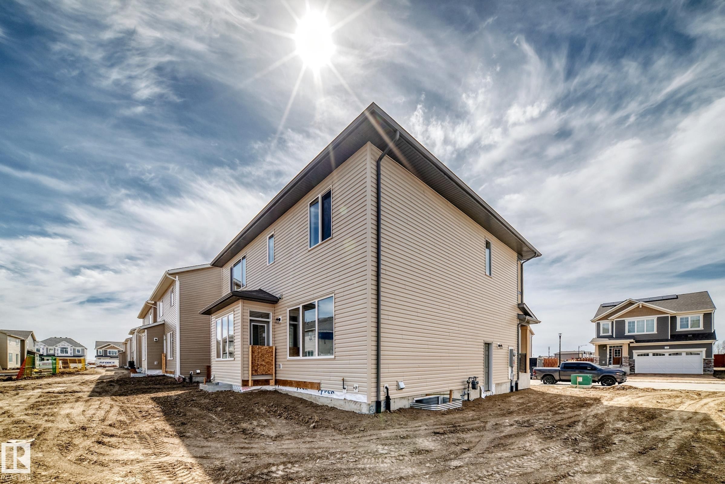 Newly constructed residence featuring beige siding and a dark shingled roof - 1603 206 Street, Edmonton, AB - Outdoor