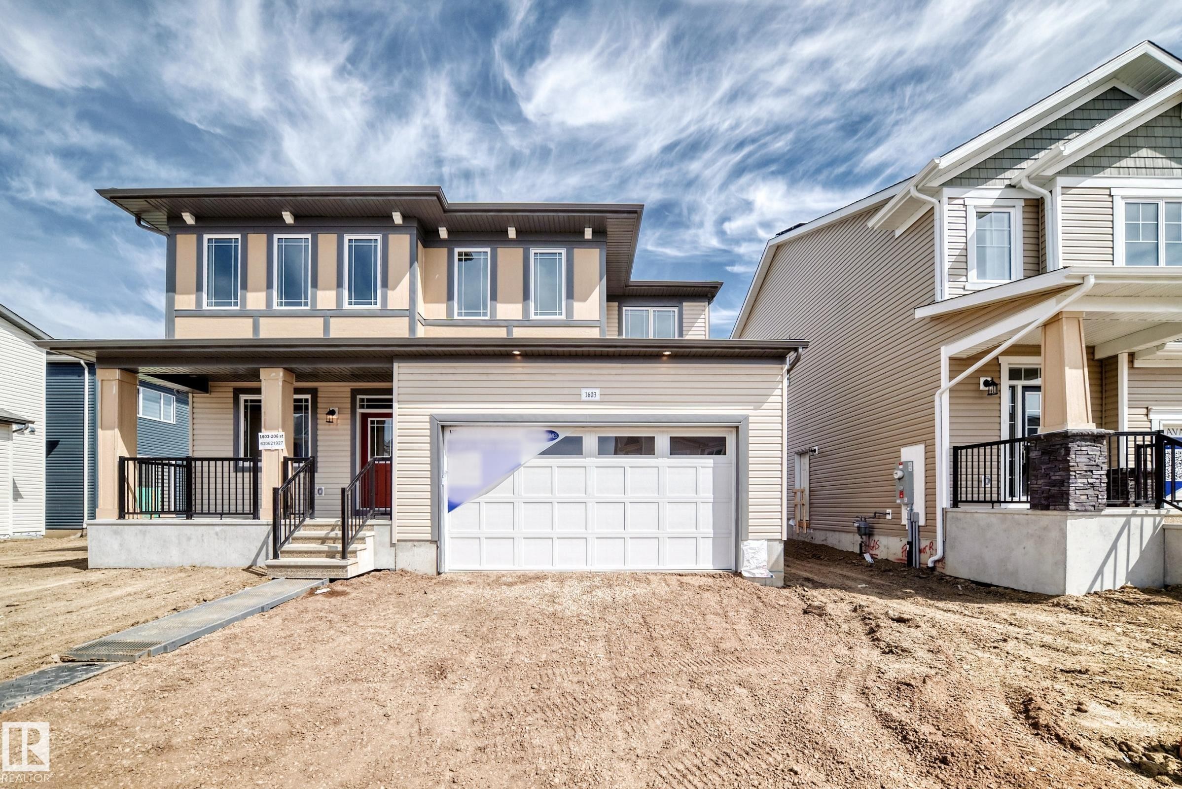 Contemporary facade featuring light-toned siding and dark trim accents - 1603 206 Street, Edmonton, AB - Outdoor With Facade