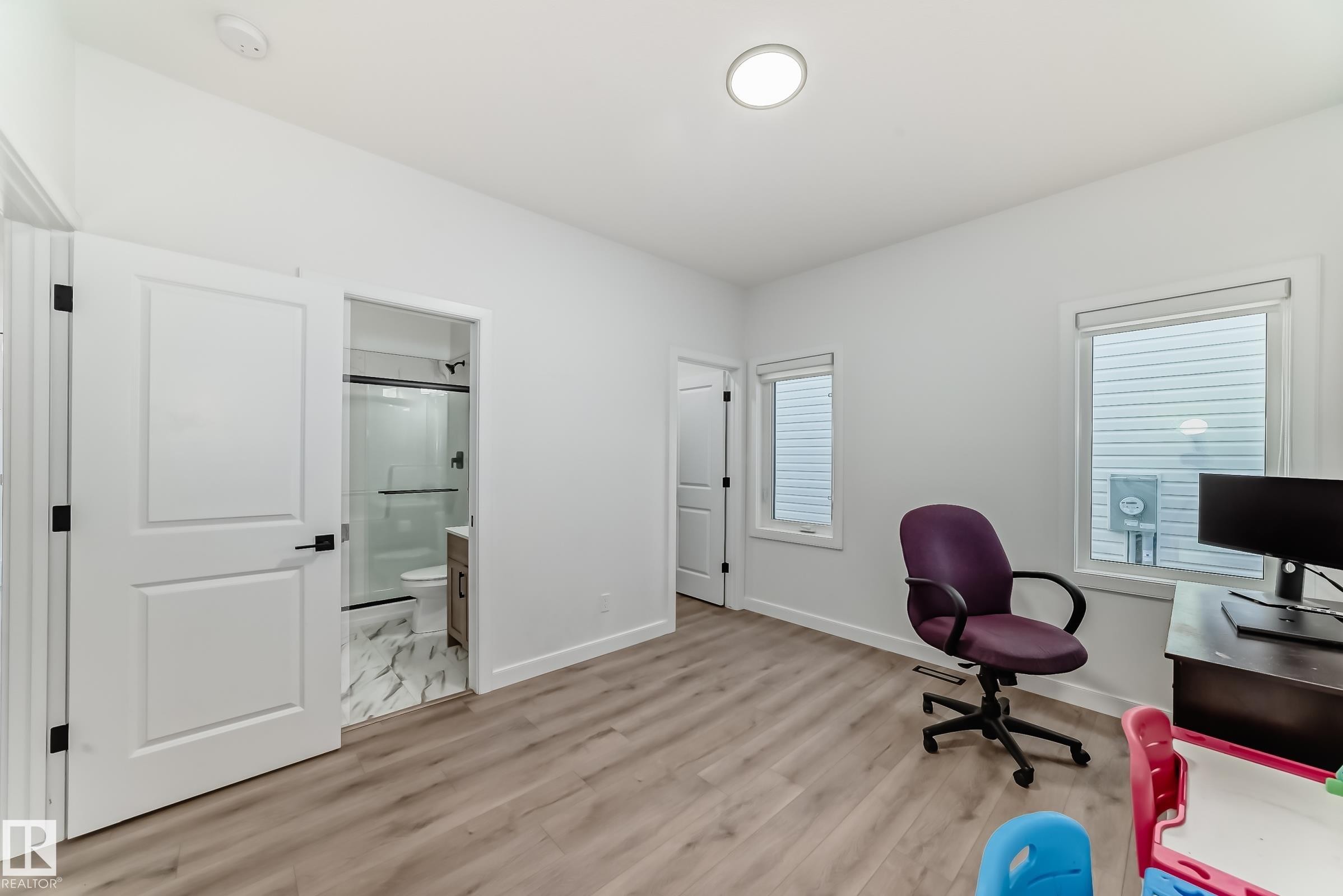 Interior room featuring wood-finish flooring, white walls, and recessed lighting - 3247 Chernowski Way, Edmonton, AB - Indoor