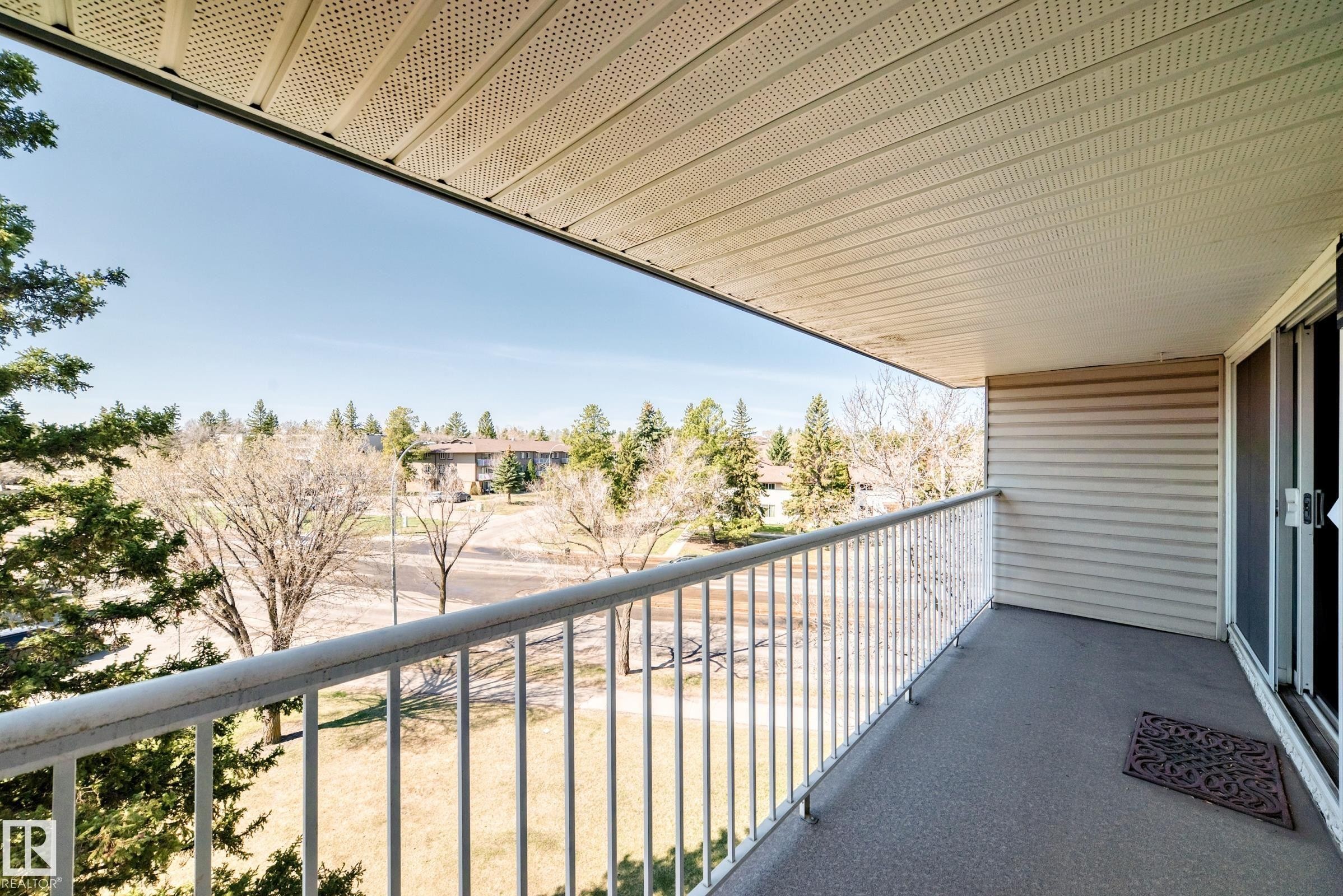 Private balcony with a metal railing, concrete flooring, and a sliding glass door - 423 5125 Riverbend Road, Edmonton, AB - Outdoor With Balcony With Exterior