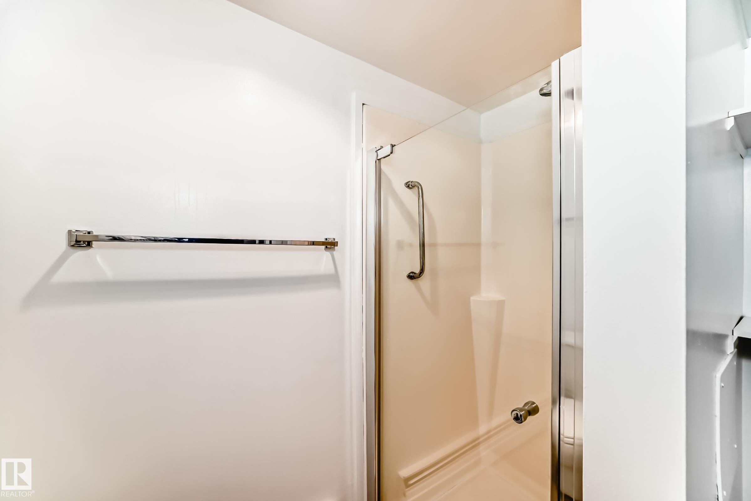 Glass-enclosed shower with a brushed chrome towel bar - 423 5125 Riverbend Road, Edmonton, AB - Indoor