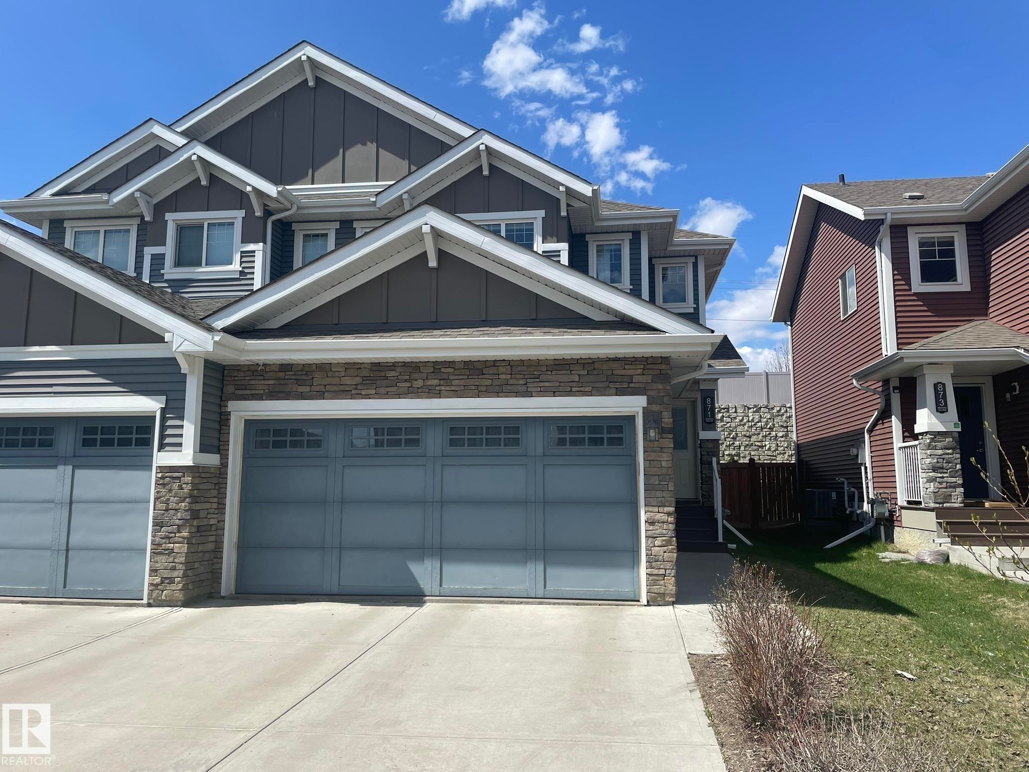 Modern multi-story property featuring a stone facade and siding exterior - 871 Ebbers Crescent, Edmonton, AB - Outdoor With Facade