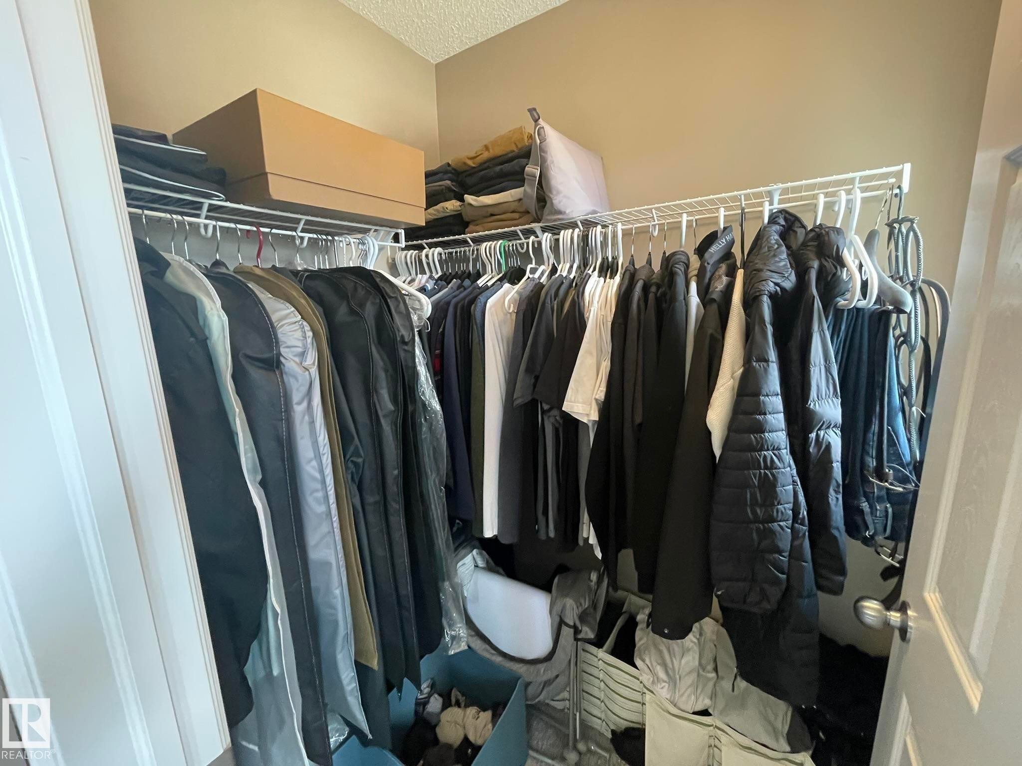 Closet featuring wire shelving system, multiple hanging rods, and light beige wall paint - 871 Ebbers Crescent, Edmonton, AB - Indoor With Storage