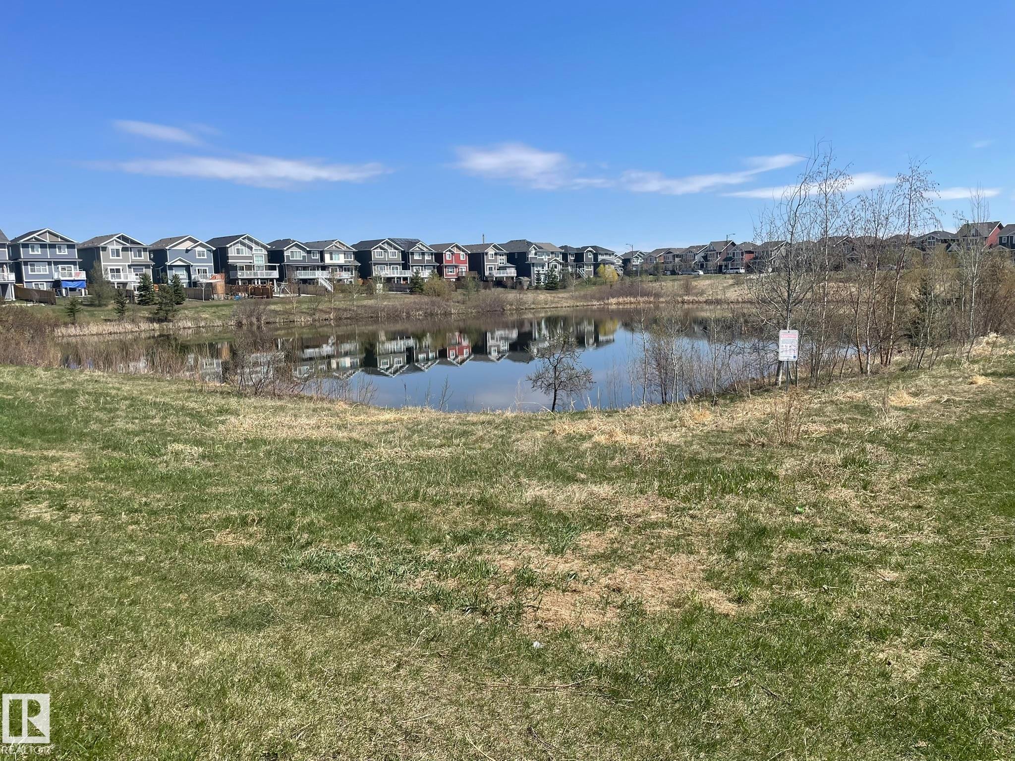 Expansive green space featuring a natural pond - 871 Ebbers Crescent, Edmonton, AB - Outdoor With View