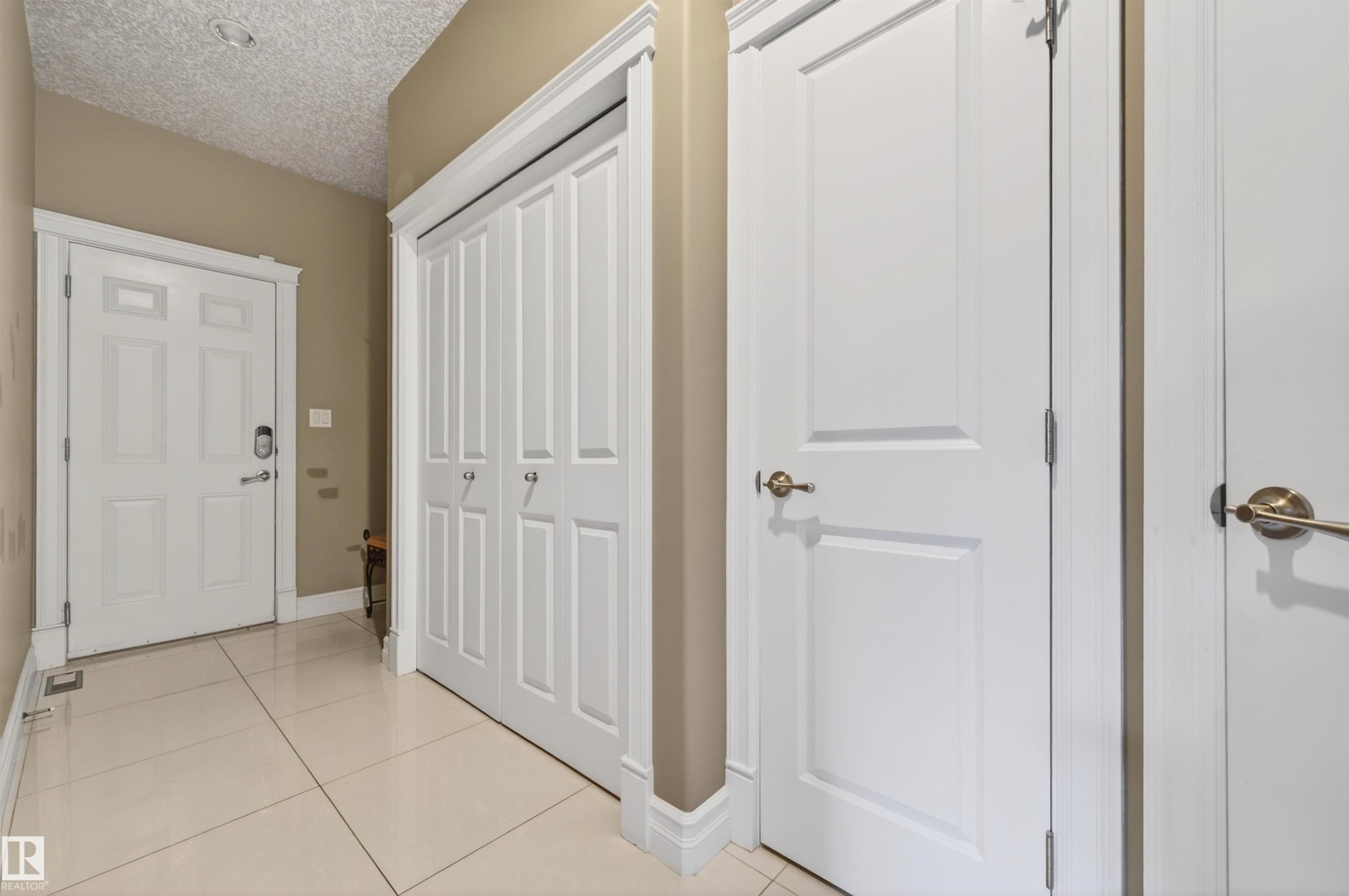 Entryway featuring light-toned tile flooring, white baseboards, and neutral wall paint - 1254 Adamson Drive, Edmonton, AB - Indoor Photo Showing Other Room