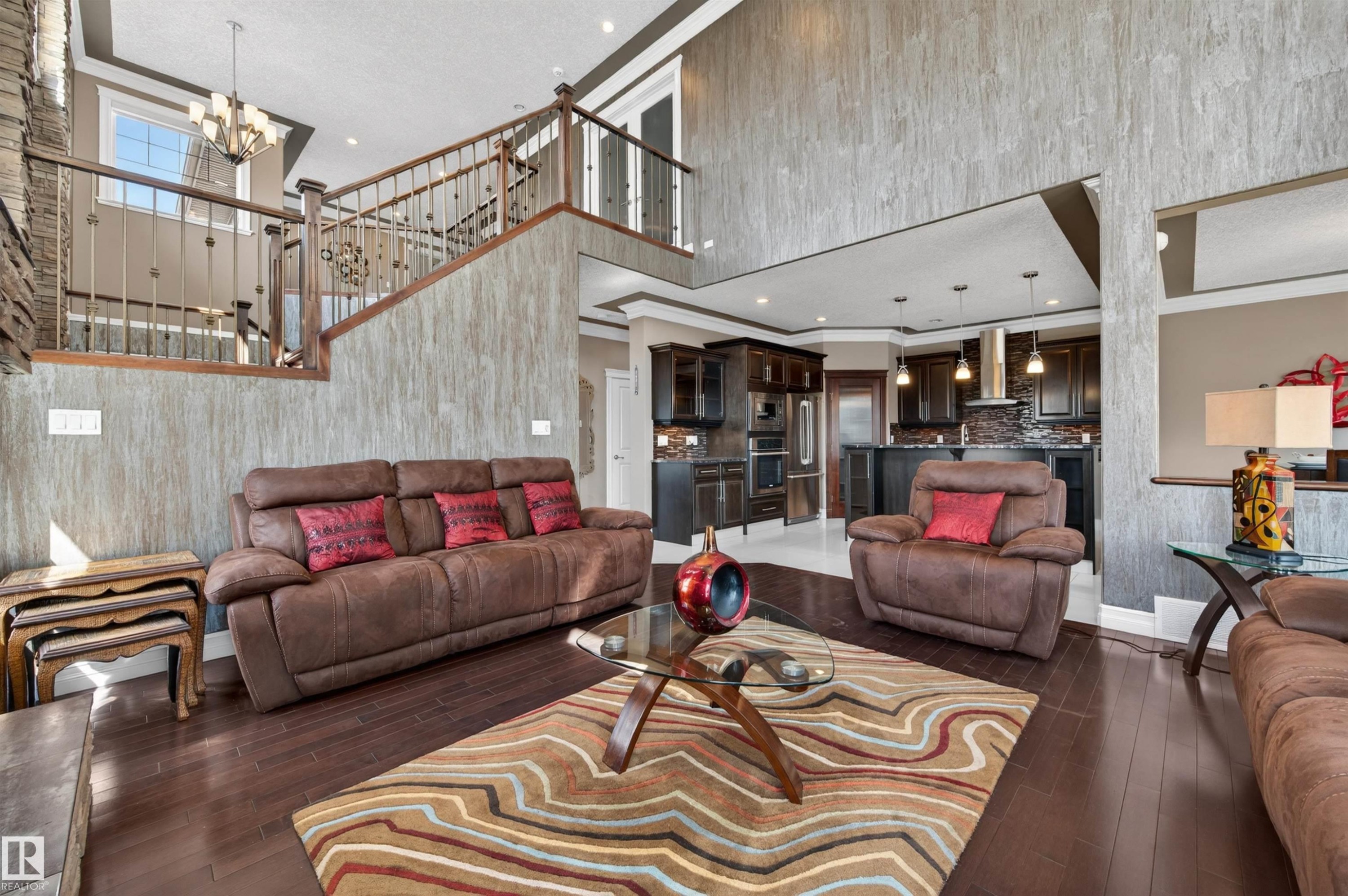 Two-story living area featuring dark wood-finish flooring and a stone-clad fireplace - 1254 Adamson Drive, Edmonton, AB - Indoor Photo Showing Living Room