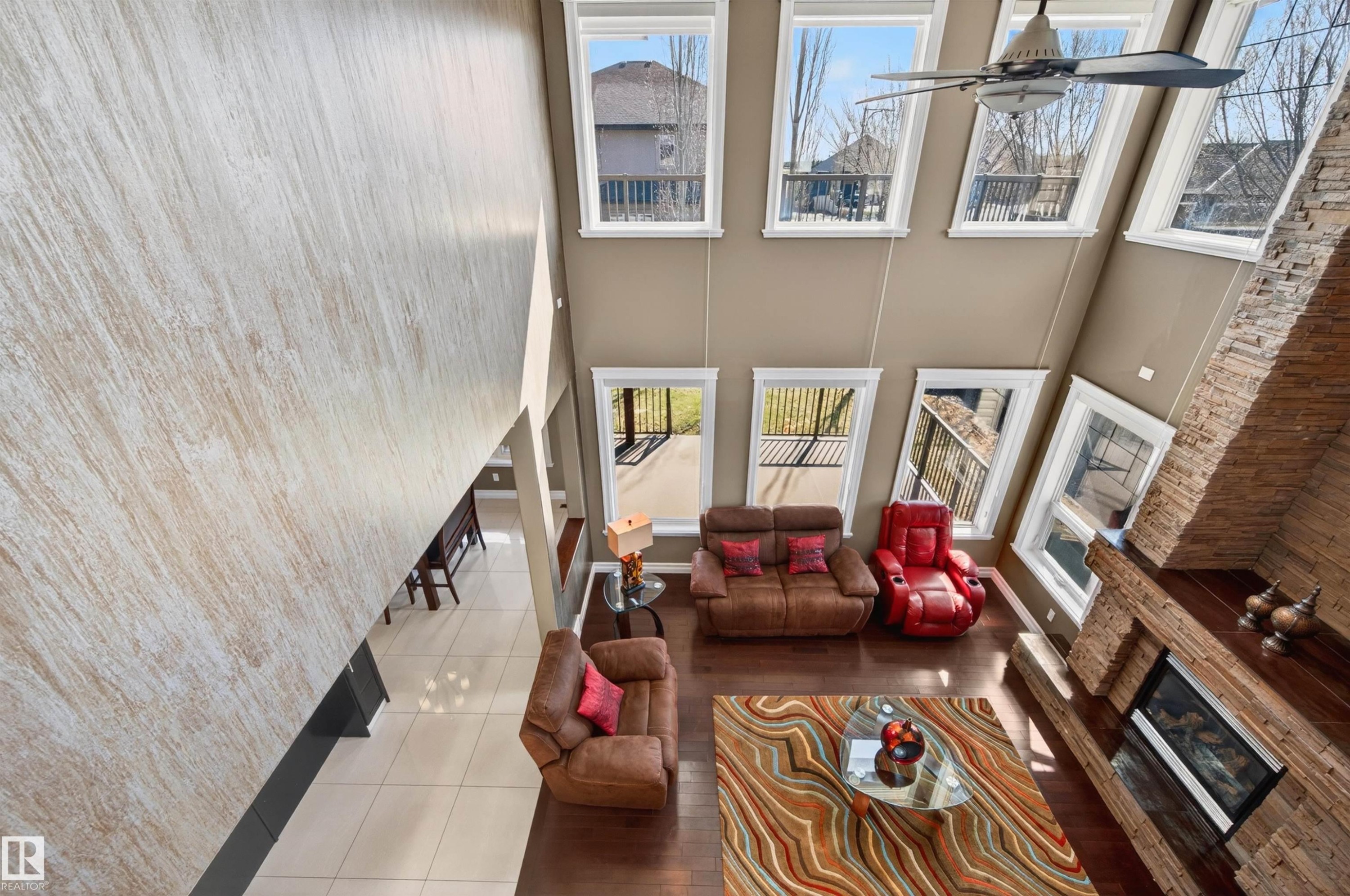Two-story living area with a stone-clad fireplace and hearth - 1254 Adamson Drive, Edmonton, AB - Indoor Photo Showing Other Room
