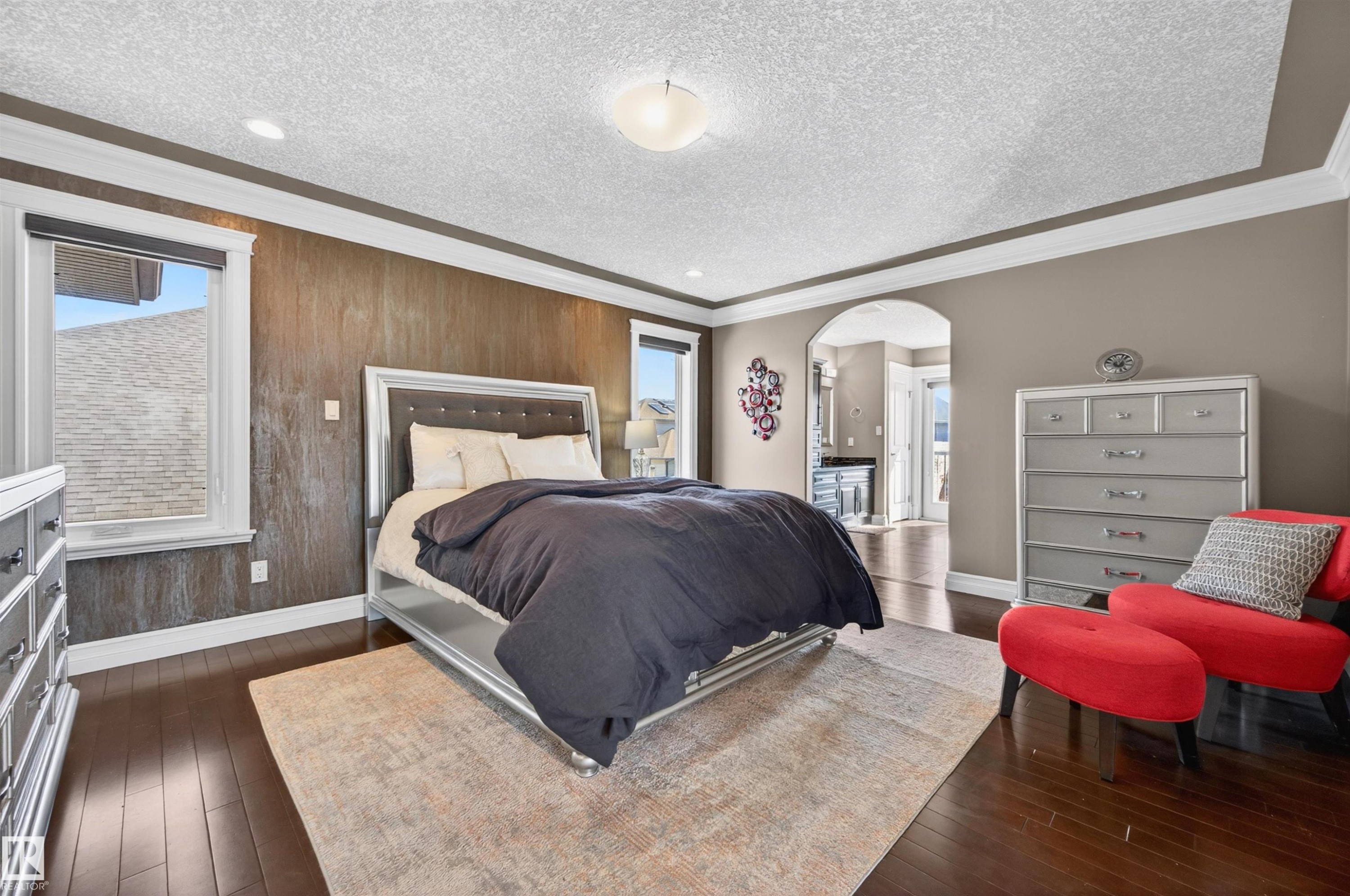 Hardwood flooring throughout this room featuring a decorative accent wall - 1254 Adamson Drive, Edmonton, AB - Indoor Photo Showing Bedroom
