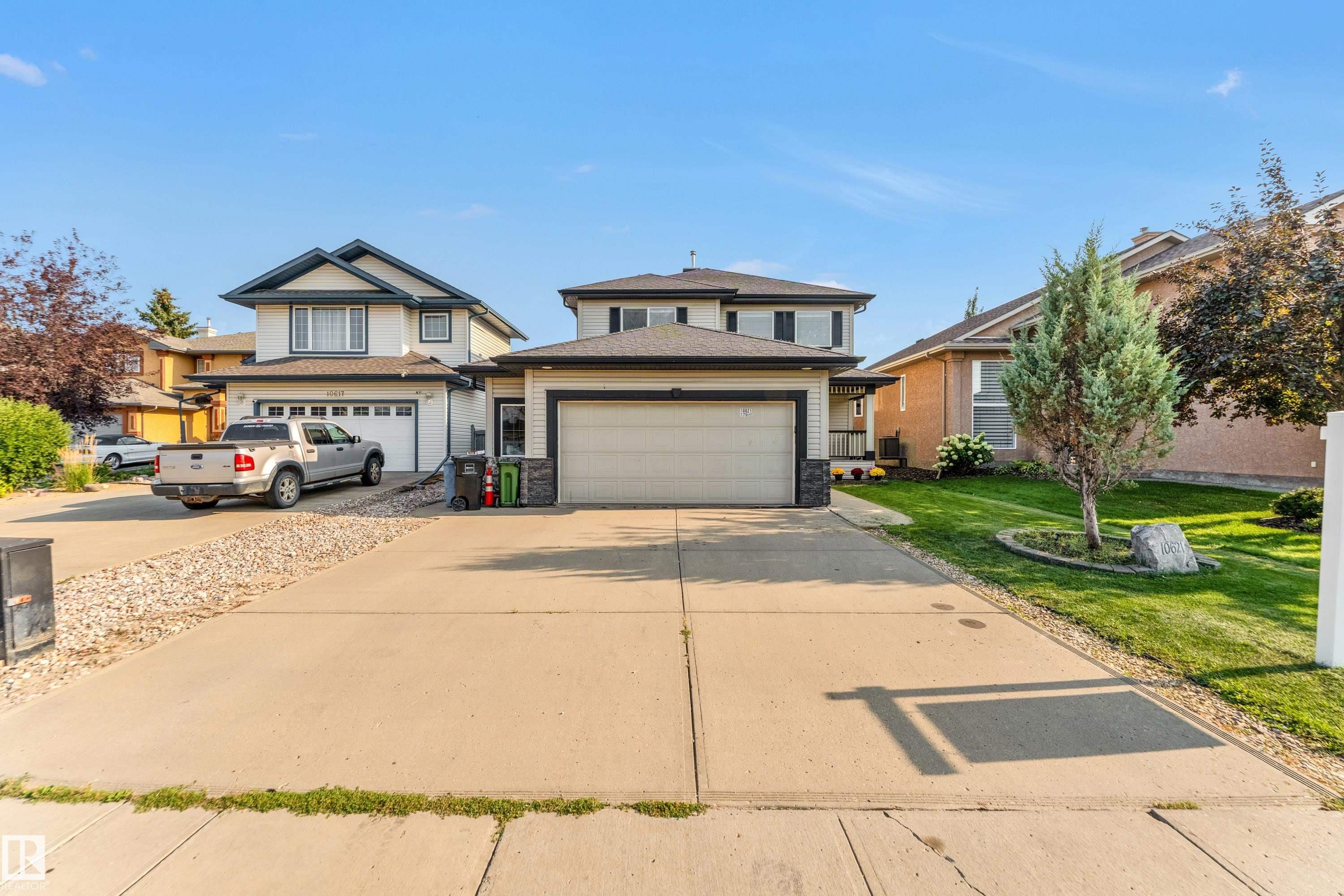 Exterior featuring a two-story design with a concrete driveway and an attached two-car garage - 10621 175A Avenue, Edmonton, AB