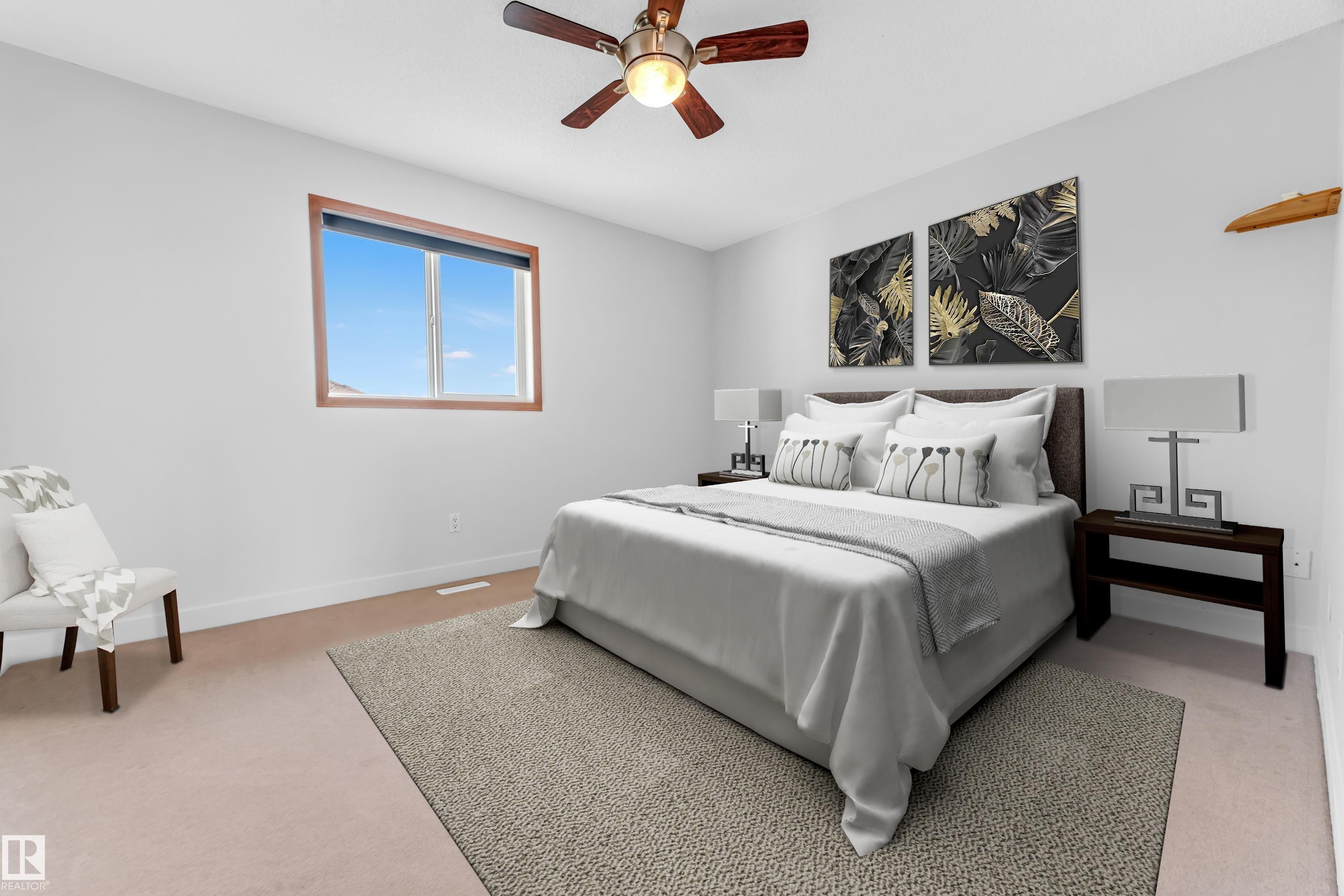 Bedroom featuring light-colored carpeting, a brown wood-finish window frame, and a ceiling fan with dark wood-finish blades - 10621 175A Avenue, Edmonton, AB