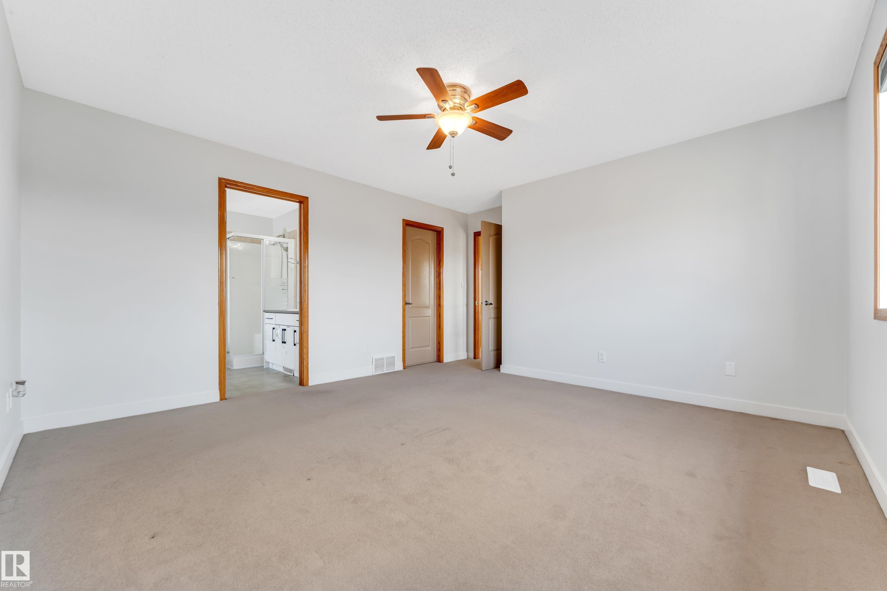 Spacious room featuring neutral carpeting and light gray walls - 10621 175A Avenue, Edmonton, AB
