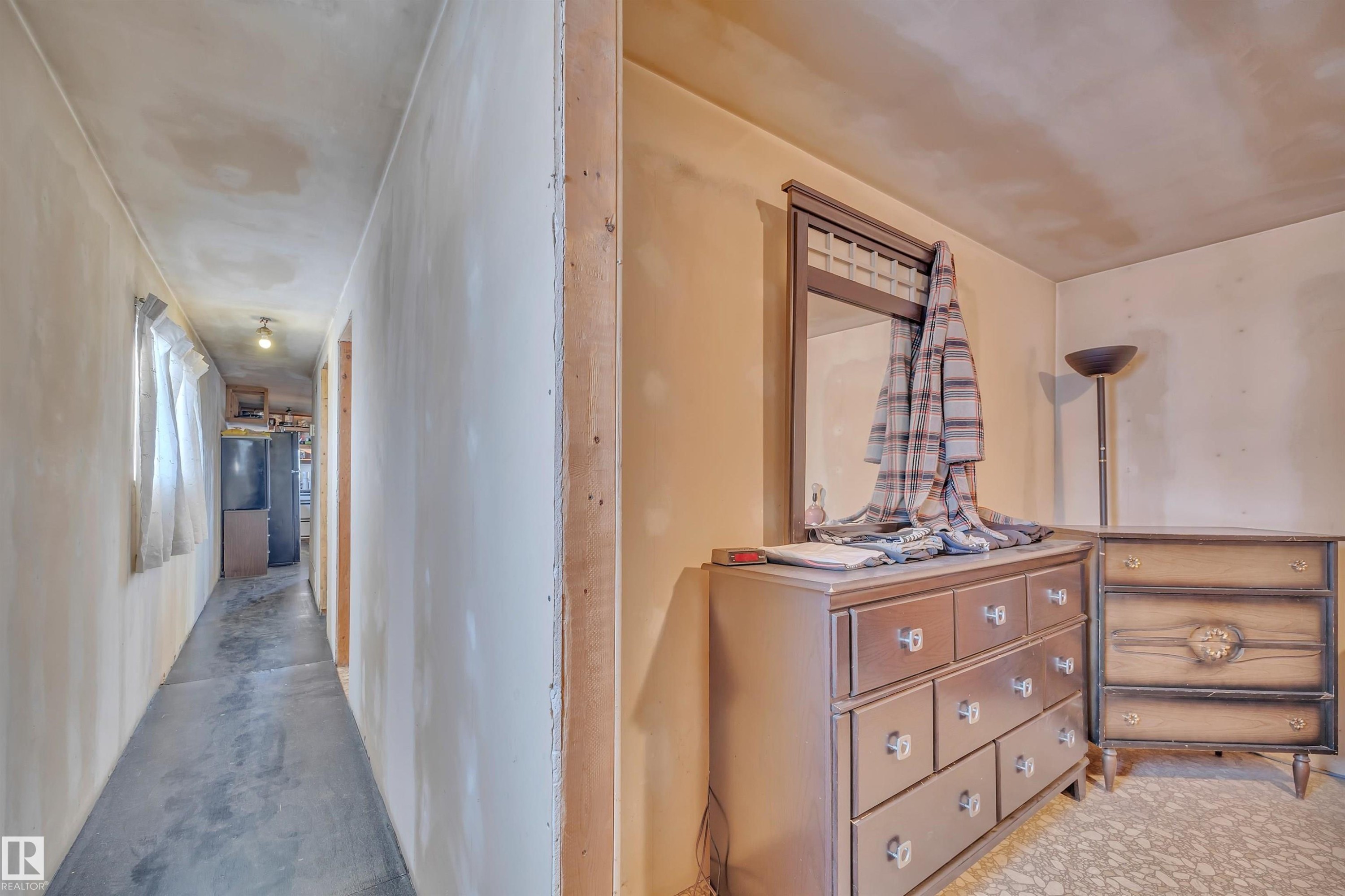 Corridor with unfinished concrete floors - 21 Calmar Mobile Home Park, Calmar, AB - Indoor Photo Showing Other Room