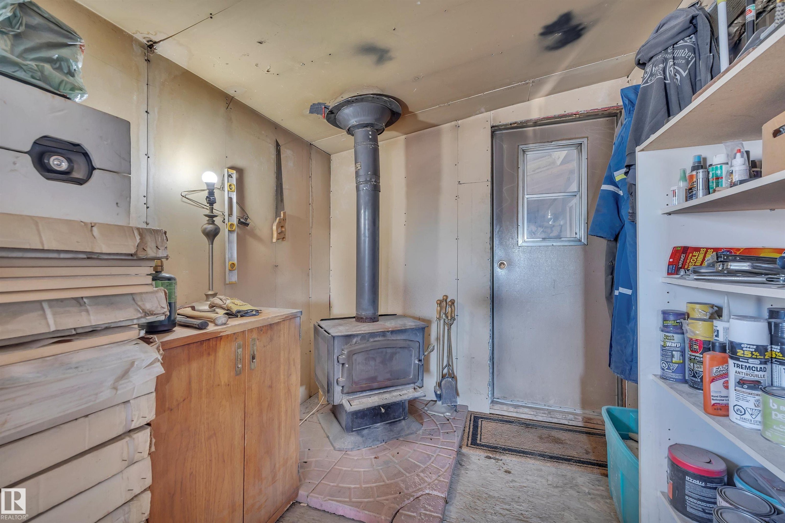 Miscellaneous room with a wood stove - 21 Calmar Mobile Home Park, Calmar, AB - Indoor