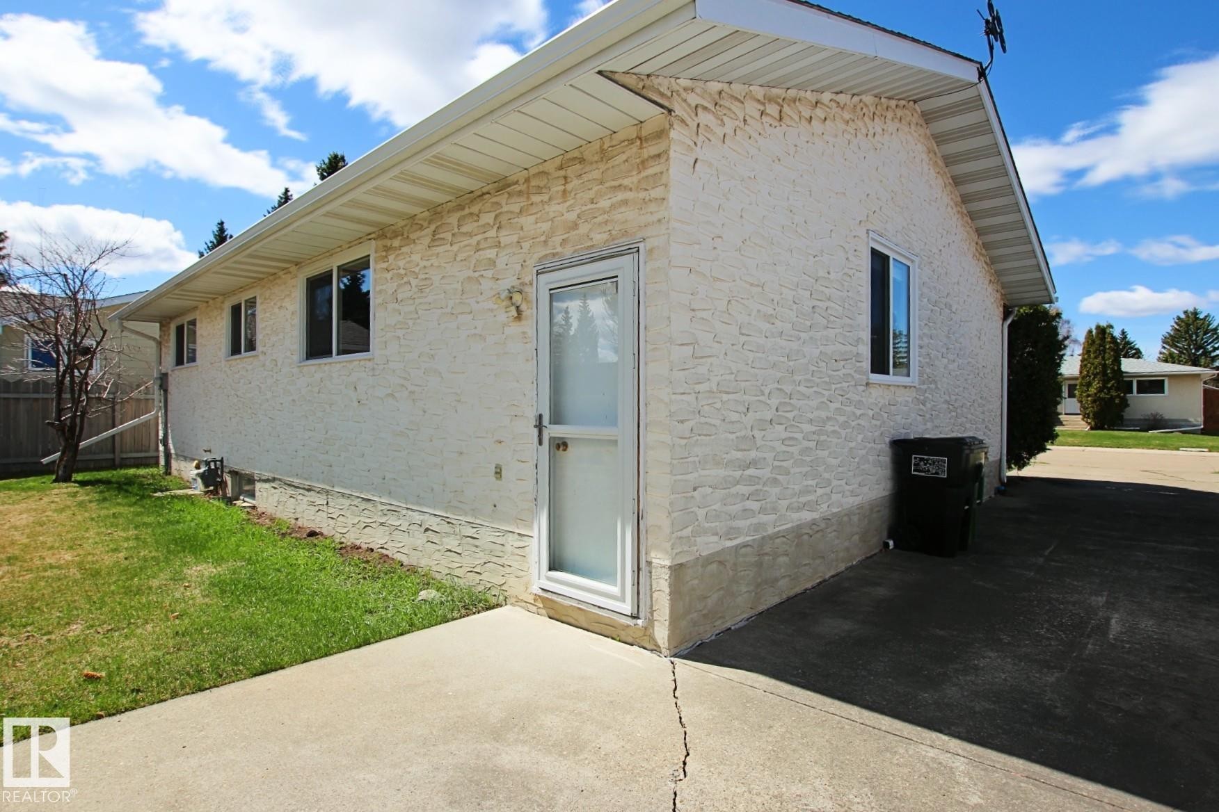 Exterior featuring textured stucco siding and white trim - 3539 104 Street, Edmonton, AB - Outdoor With Exterior