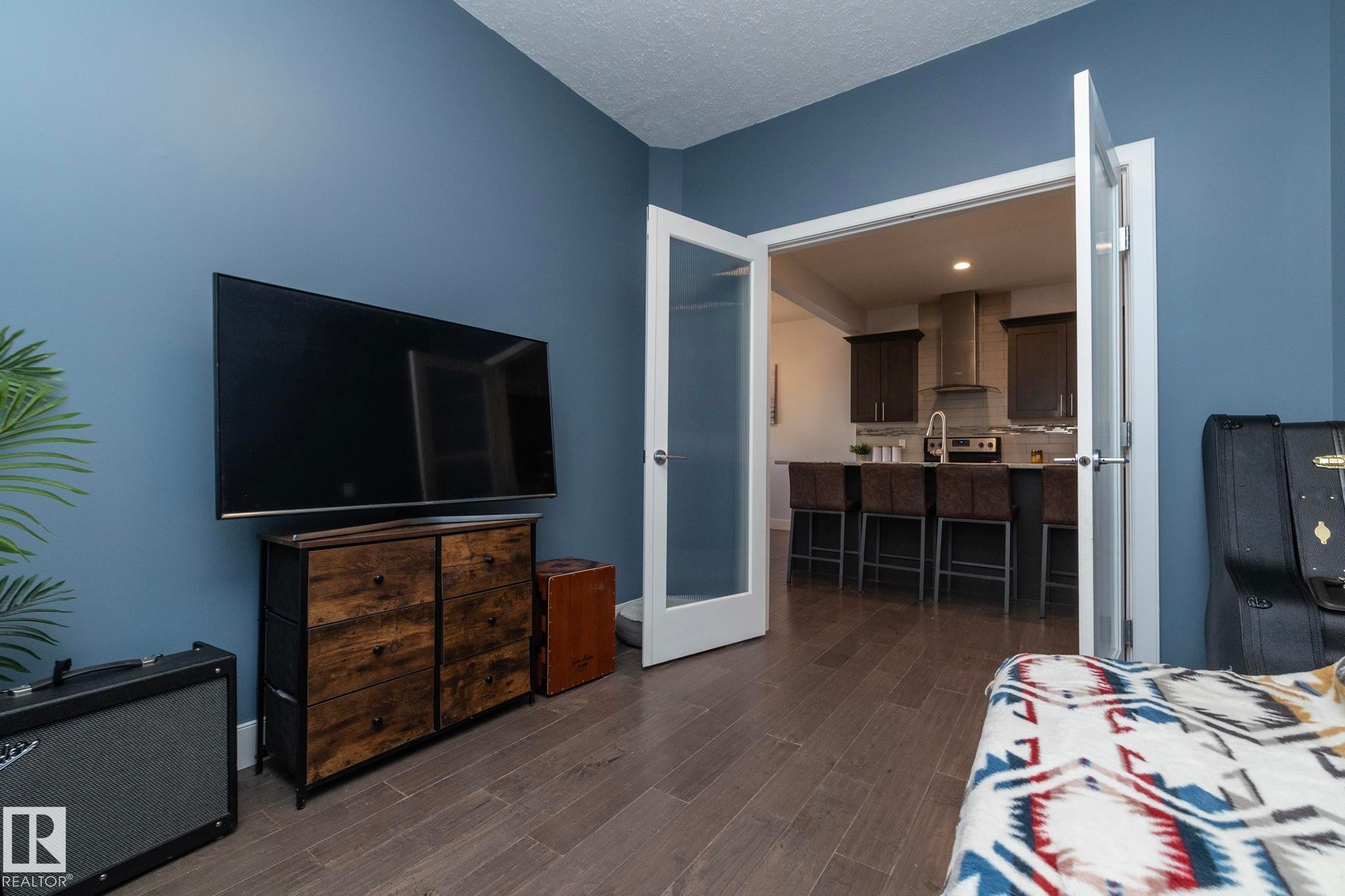 Interior space with wood-finish flooring and blue walls - 2016 Redtail Common, Edmonton, AB - Indoor Photo Showing Bedroom