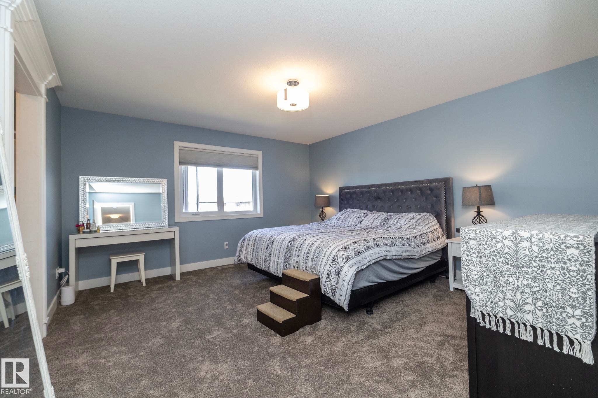 Spacious room featuring light blue walls and neutral tone carpeting - 2016 Redtail Common, Edmonton, AB - Indoor Photo Showing Bedroom