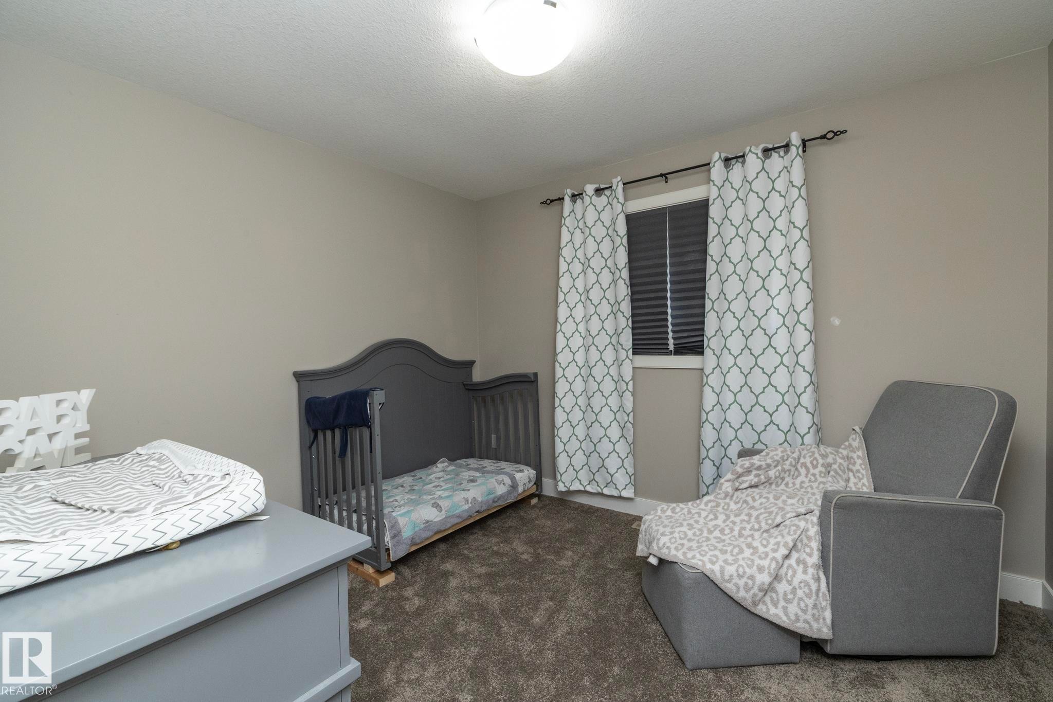 Neutral-toned wall paint with textured carpeting - 2016 Redtail Common, Edmonton, AB - Indoor Photo Showing Bedroom