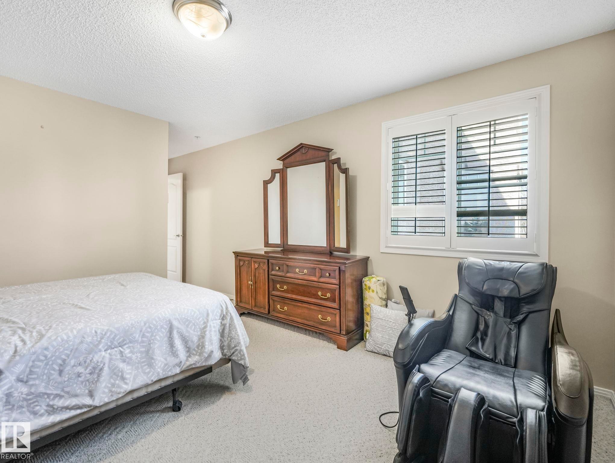 Bedroom with neutral wall color and light-colored carpeting - 317 2420 108 Street, Edmonton, AB - Indoor Photo Showing Bedroom