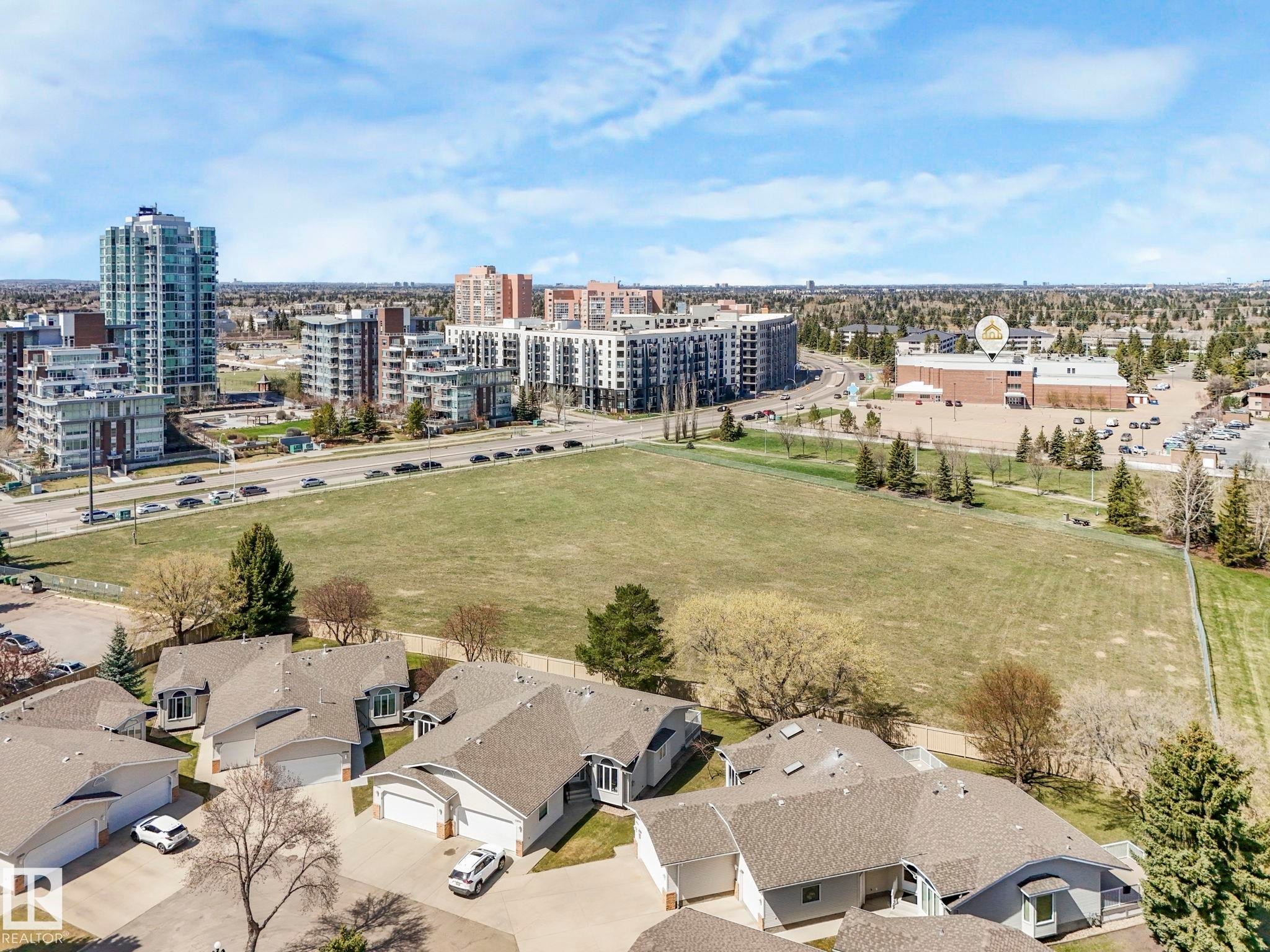 Aerial perspective showcasing residential properties with light-colored siding and shingle roofs - 317 2420 108 Street, Edmonton, AB - Outdoor With View