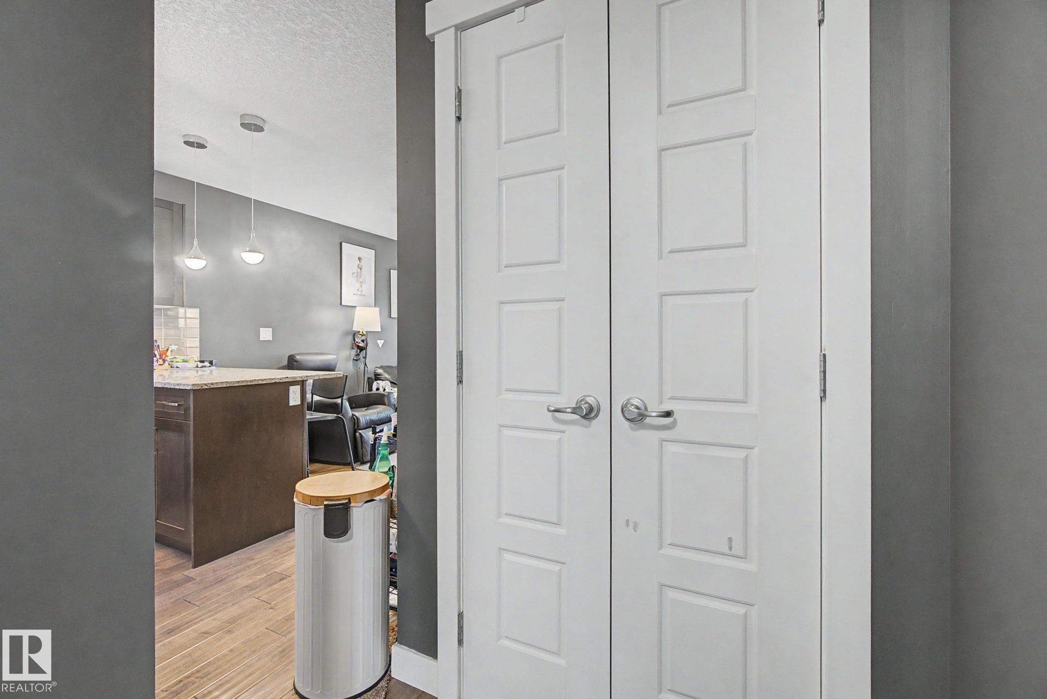White paneled bifold doors with brushed nickel hardware - 210 401 Southfork Drive, Leduc, AB - Indoor Photo Showing Other Room