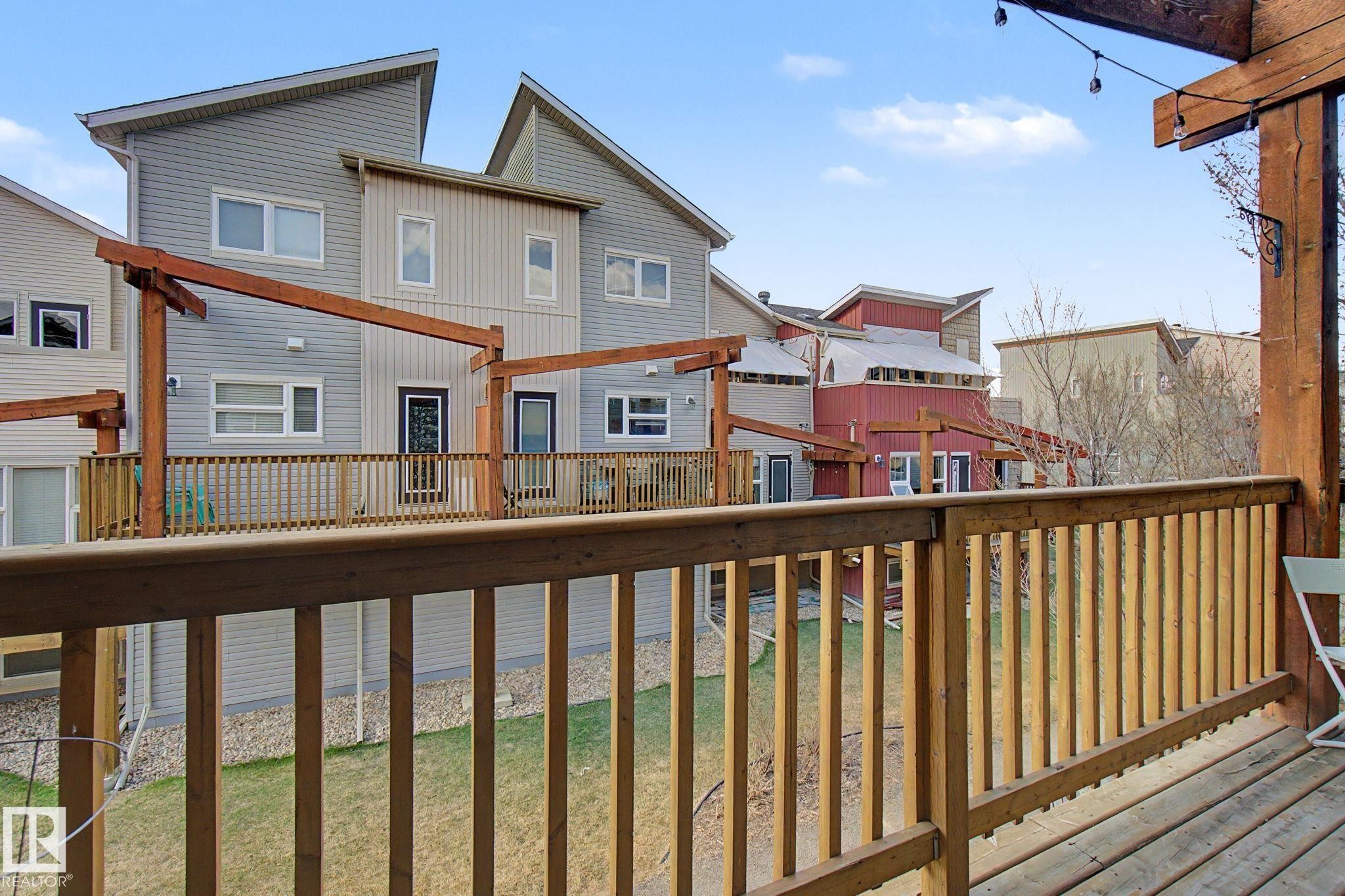 Wood deck with railings and string lights - 210 401 Southfork Drive, Leduc, AB - Outdoor With Balcony With Exterior