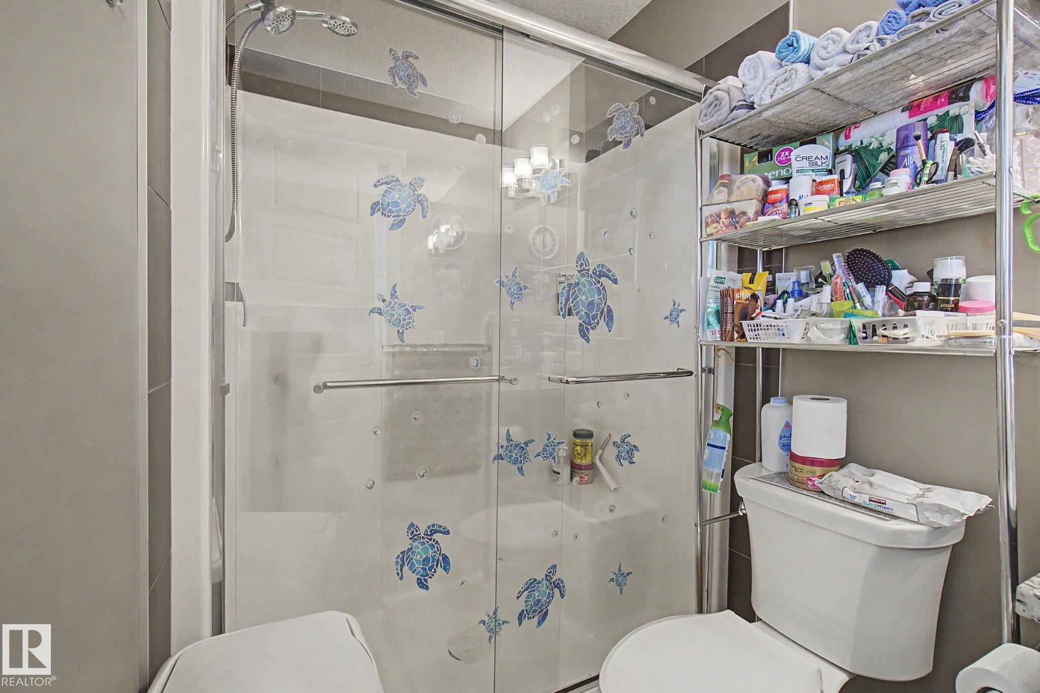 Walk-in shower with clear glass enclosure and chrome hardware - 210 401 Southfork Drive, Leduc, AB - Indoor Photo Showing Bathroom