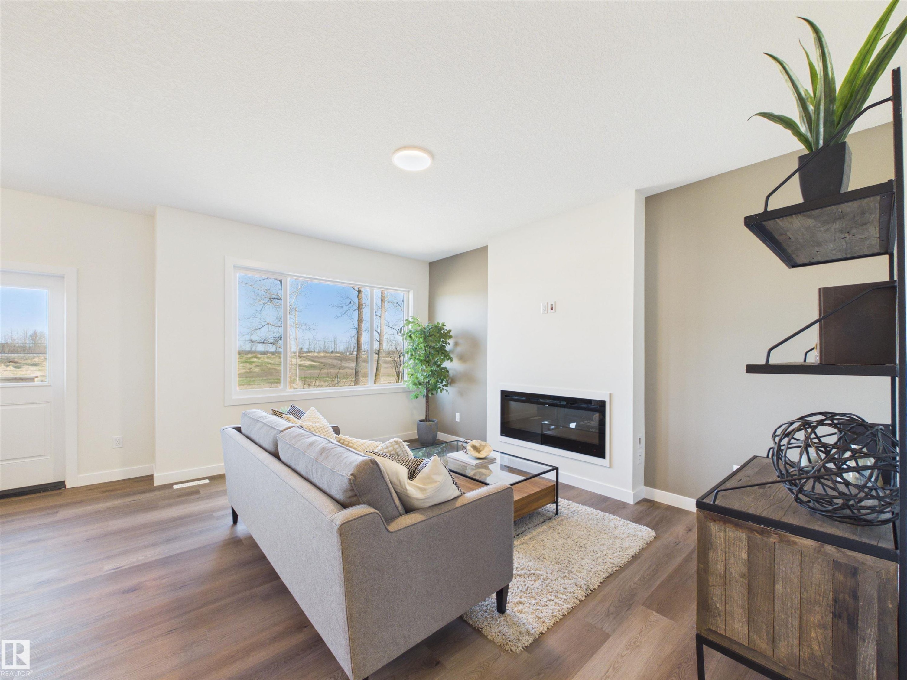 407 Brickyard Point(E), Stony Plain, AB - Indoor Photo Showing Living Room With Fireplace