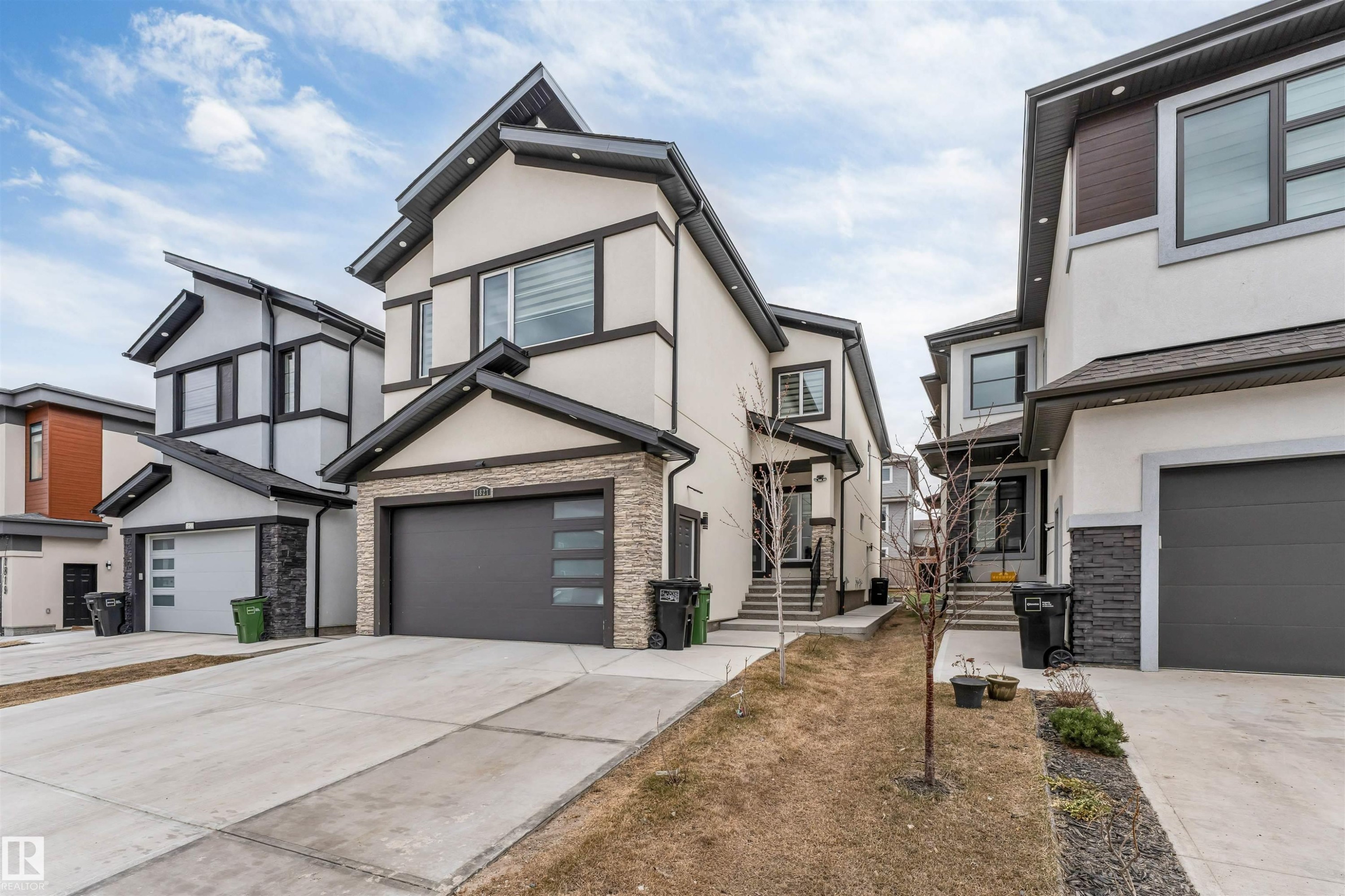 Modern multi-story property featuring a light-colored stucco exterior with dark trim accents - 1827 17 Avenue, Edmonton, AB - Outdoor With Facade