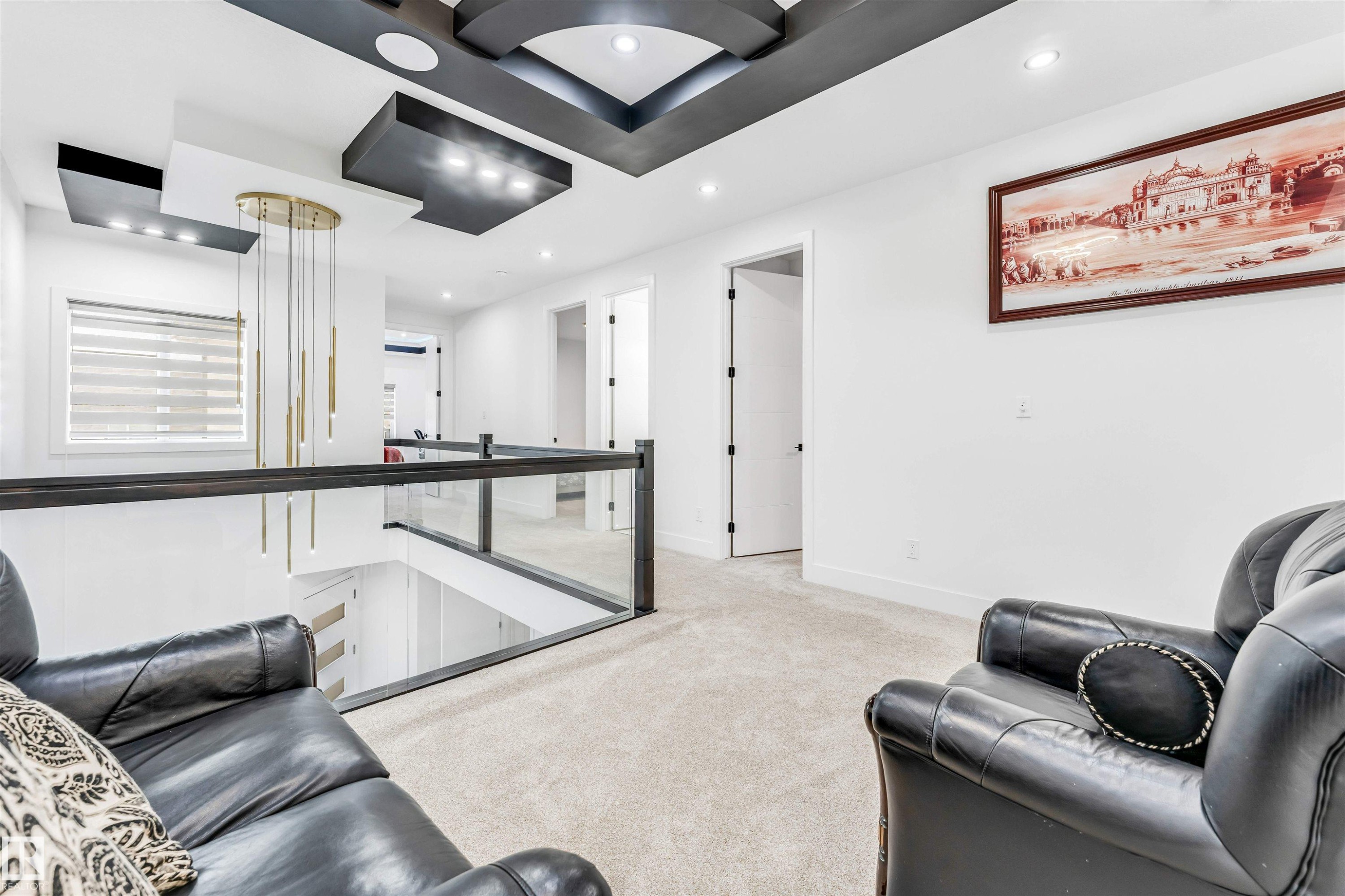 Upper level hallway featuring a decorative multi-tier ceiling with integrated lighting, recessed lighting, and a modern chandelier - 1827 17 Avenue, Edmonton, AB - Indoor Photo Showing Other Room
