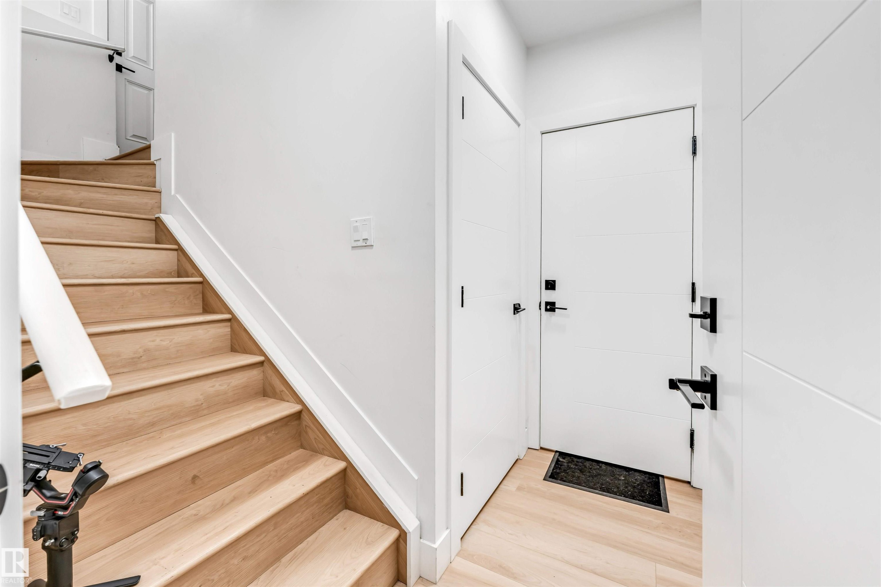 Light wood-finish staircase and flooring - 1827 17 Avenue, Edmonton, AB - Indoor Photo Showing Other Room