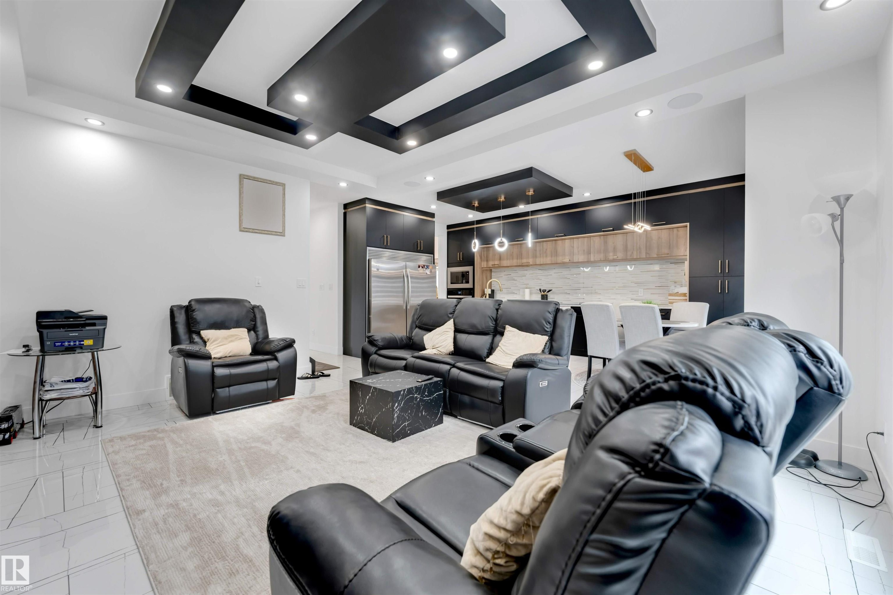 Open-concept living space with recessed lighting and a layered tray ceiling design - 1827 17 Avenue, Edmonton, AB - Indoor