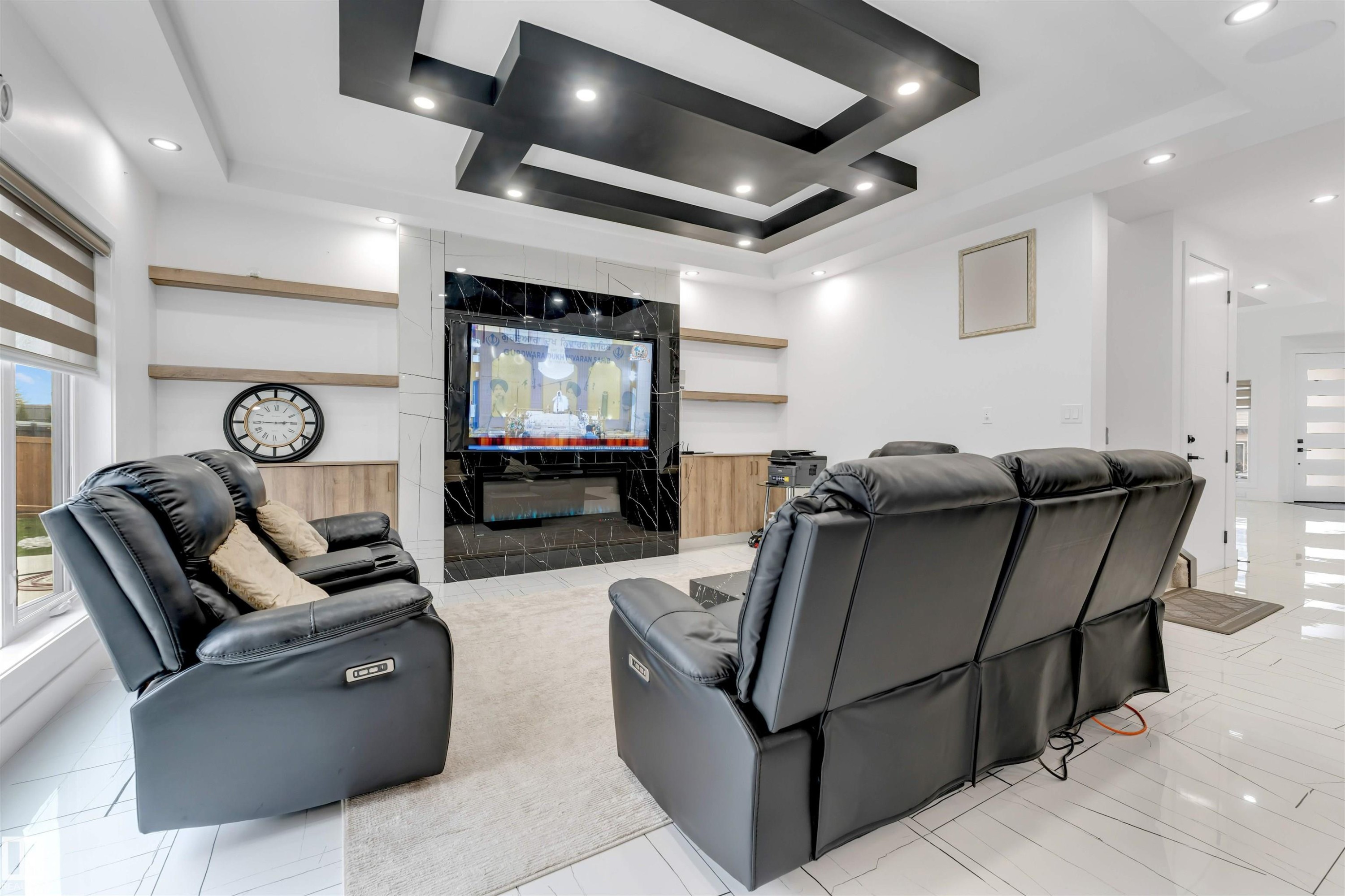 Spacious living area featuring a striking black and white ceiling design, recessed lighting, and large format white tile flooring - 1827 17 Avenue, Edmonton, AB - Indoor