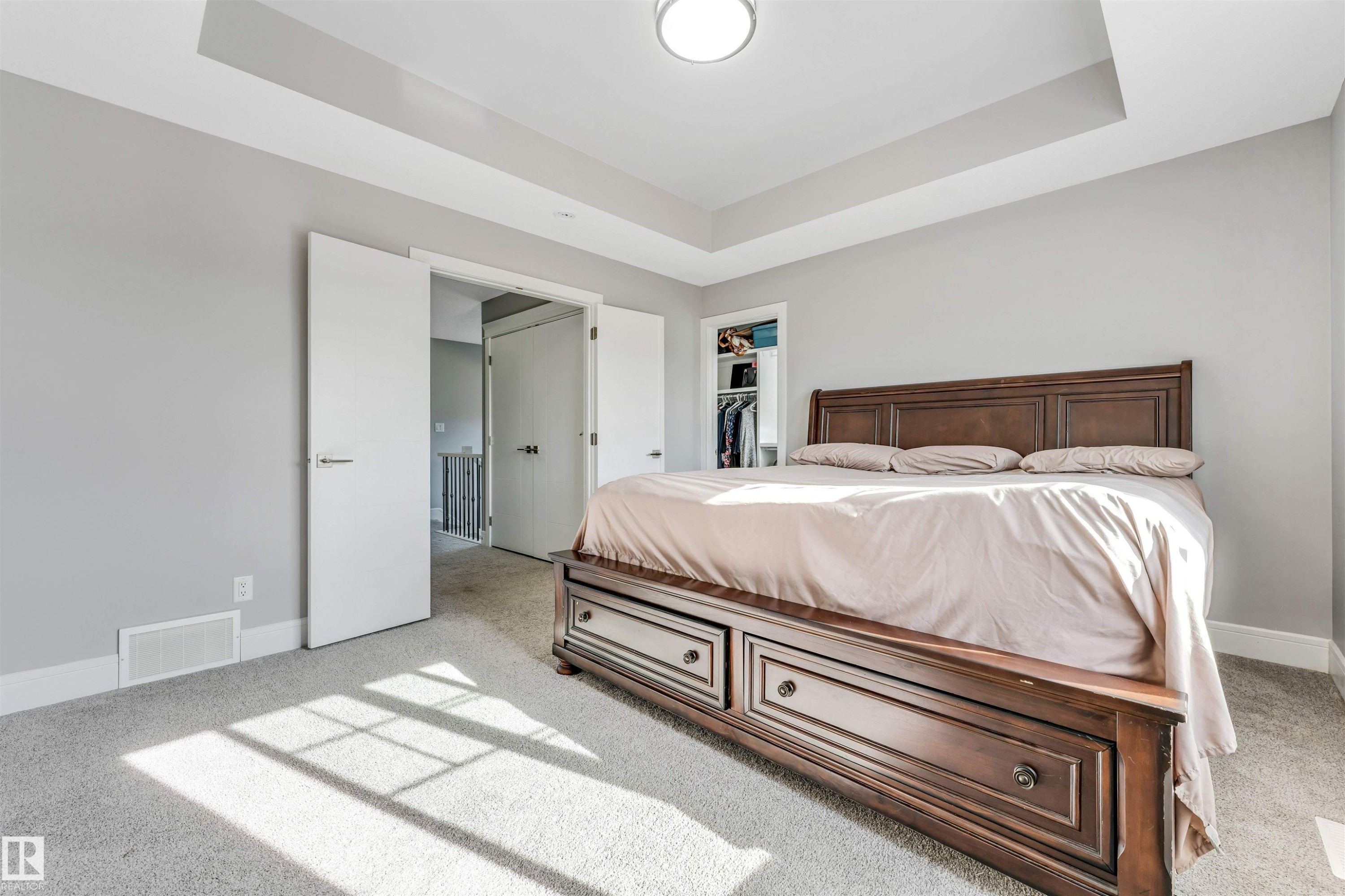 Recessed tray ceiling with central flush-mount lighting - 1103 29 Street, Edmonton, AB - Indoor Photo Showing Bedroom