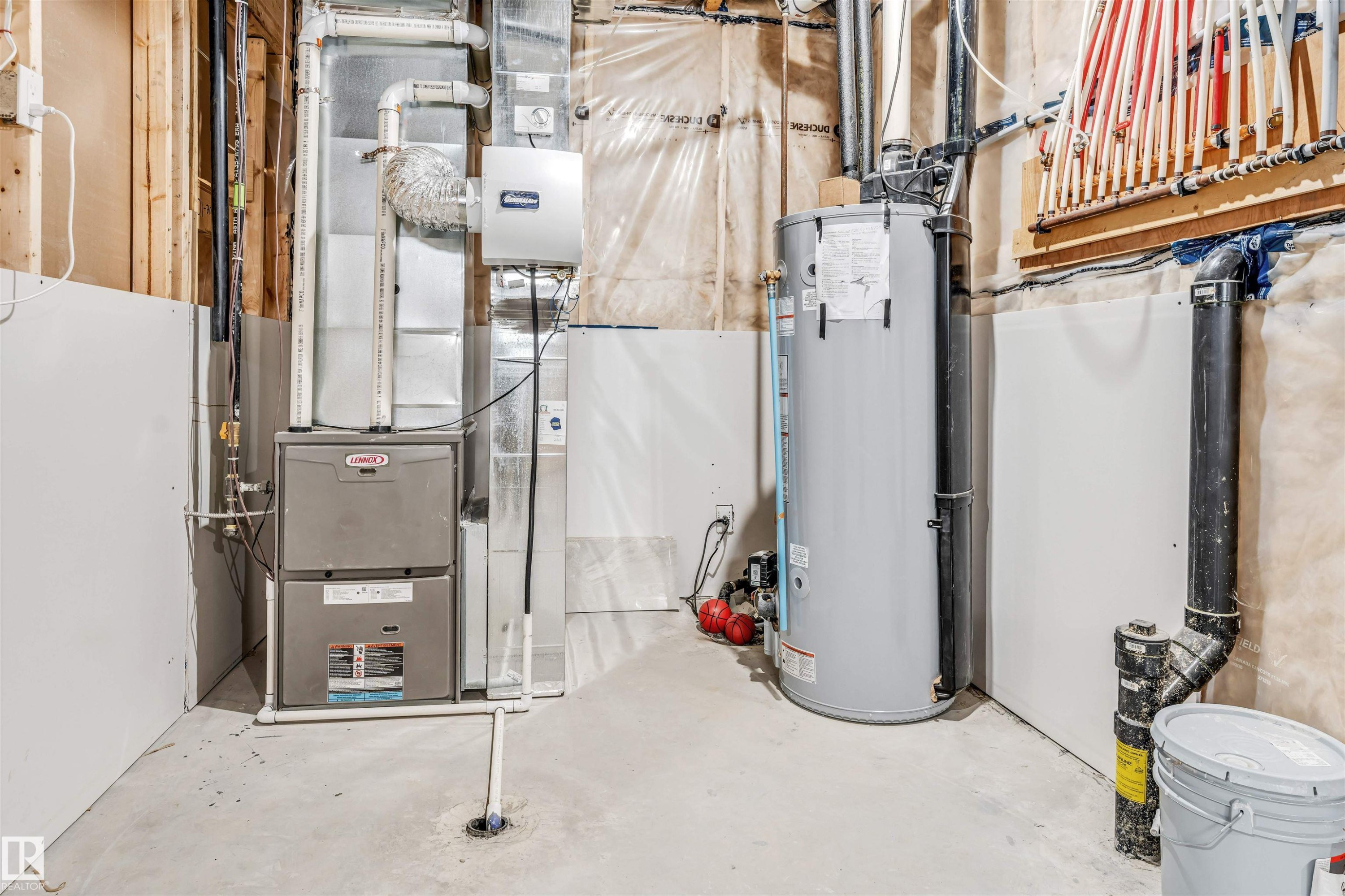 Utility room featuring a furnace, water heater, and PEX manifold system - 1103 29 Street, Edmonton, AB - Indoor Photo Showing Basement