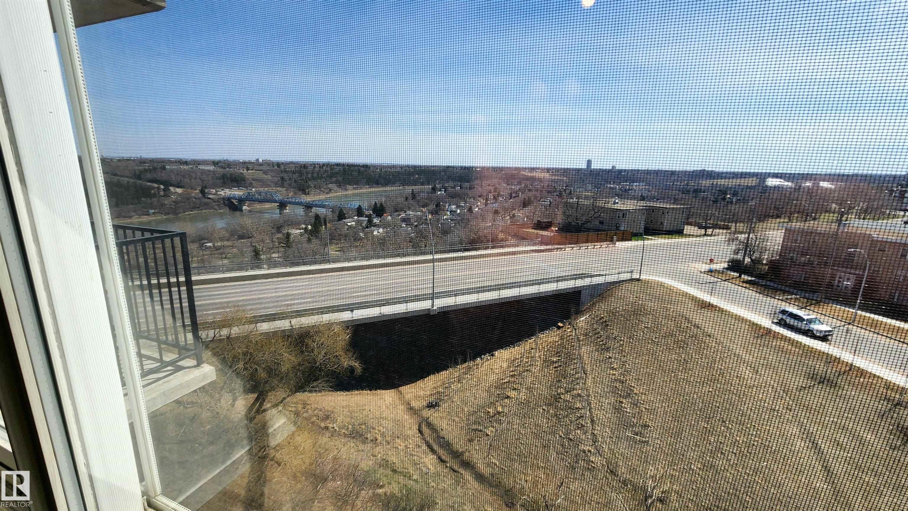 View From PRIMARY Bedroom! Expansive outdoor panorama featuring a river, bridge, and distant cityscape - 603 9028 Jasper Avenue, Edmonton, AB - With View