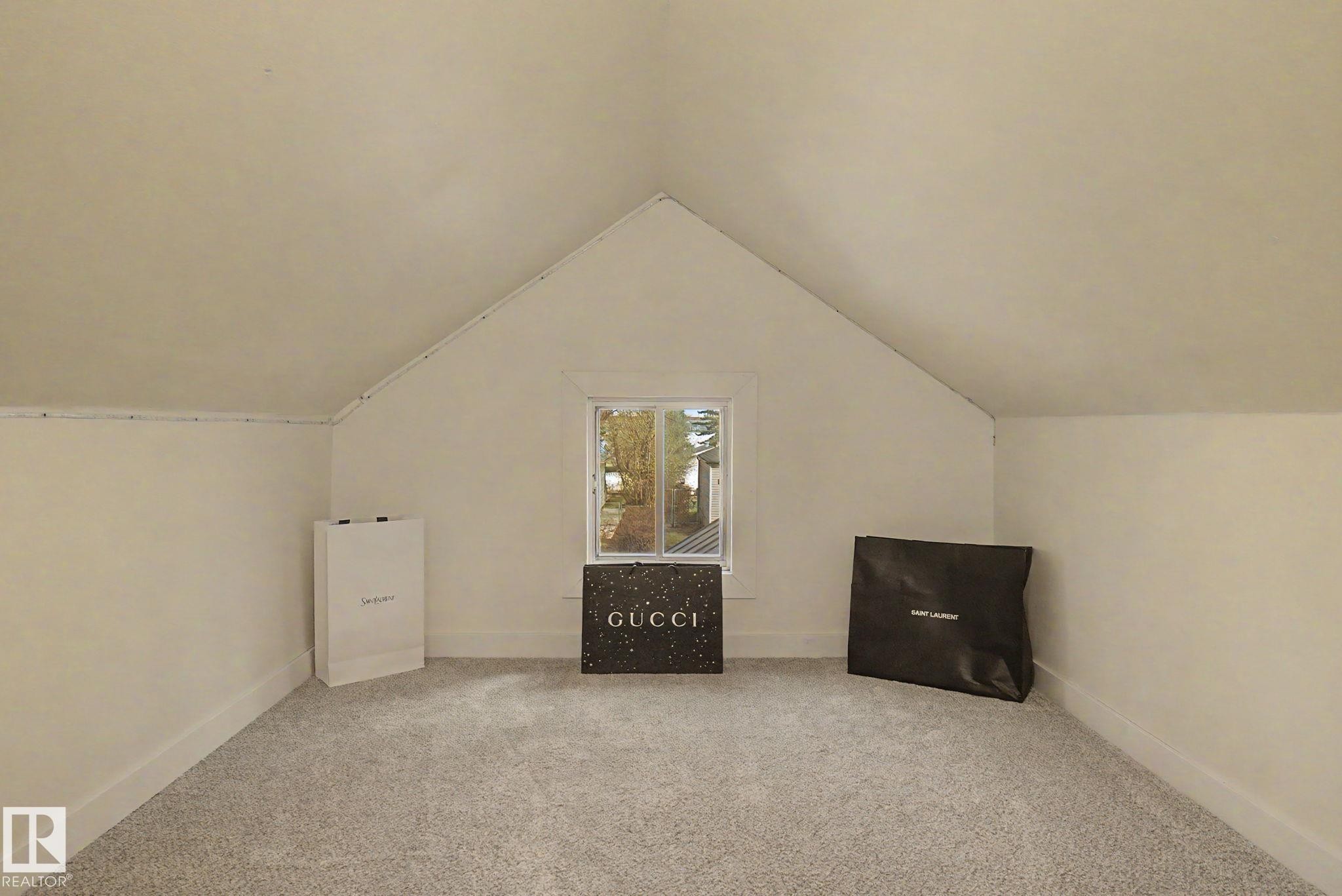 Room featuring neutral carpeting and a central window - 11512 122 St, Edmonton, AB - Indoor
